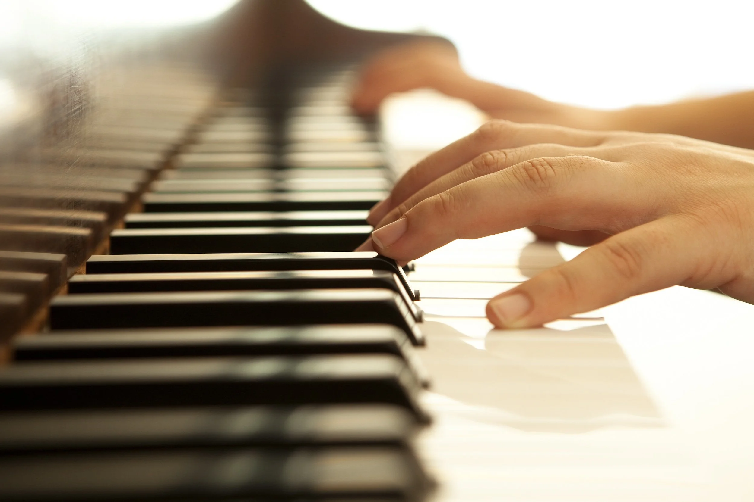 Student hands on piano keys during a private music lesson
