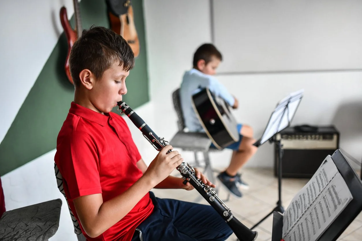 Teenage clarinet student rehearsing in a classroom setting
