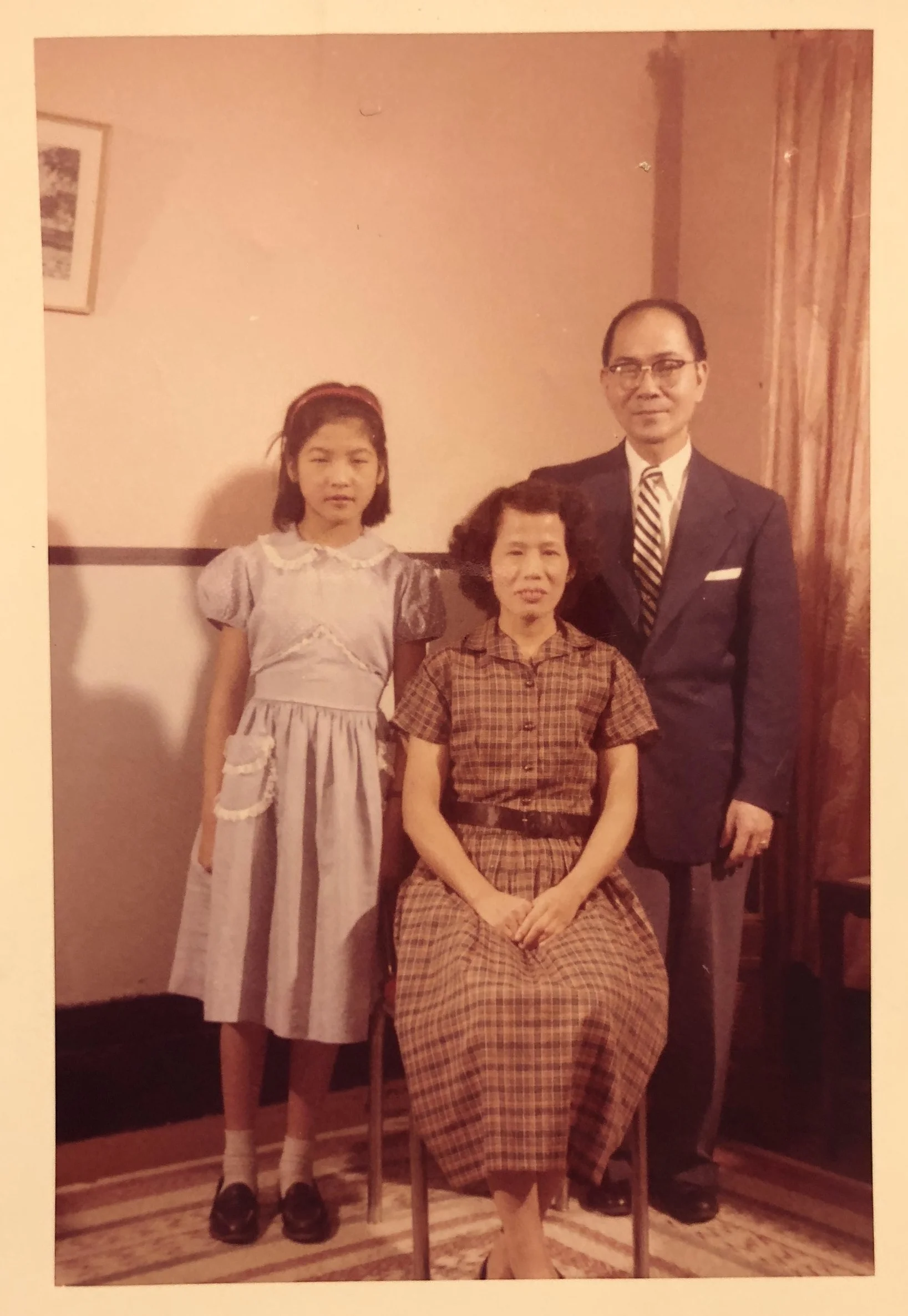 &nbsp;&nbsp;&nbsp;&nbsp;&nbsp;&nbsp;&nbsp;Cynthia Yee, wearing her first store-bought dress, with her parents, May Soon Gee and Walter Yee, 116 Hudson Street, 1959.&nbsp;&nbsp;(photo taken by Eddie Moon Fun Yee)&nbsp;