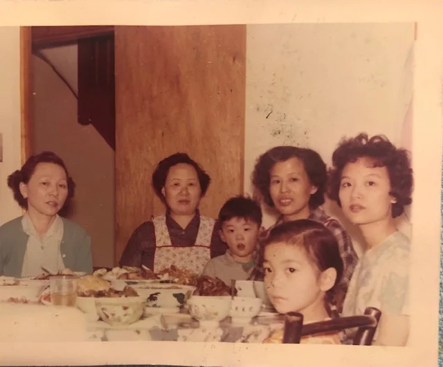 Women’s table in the kitchen with Cynthia’s paper sister in-law, Ah Goo, nephew, mom, niece and Aunty Cheong Sim; courtesy of the author