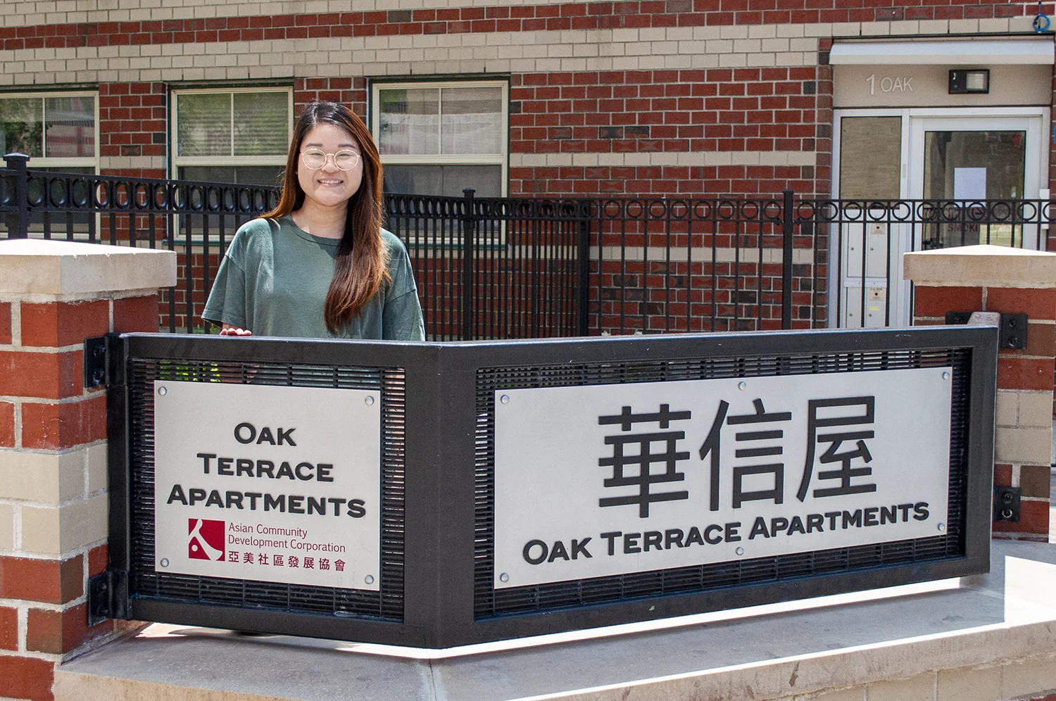 Erica in front of her childhood home at Oak Terrace Apartments; photo by Christine Nguyen