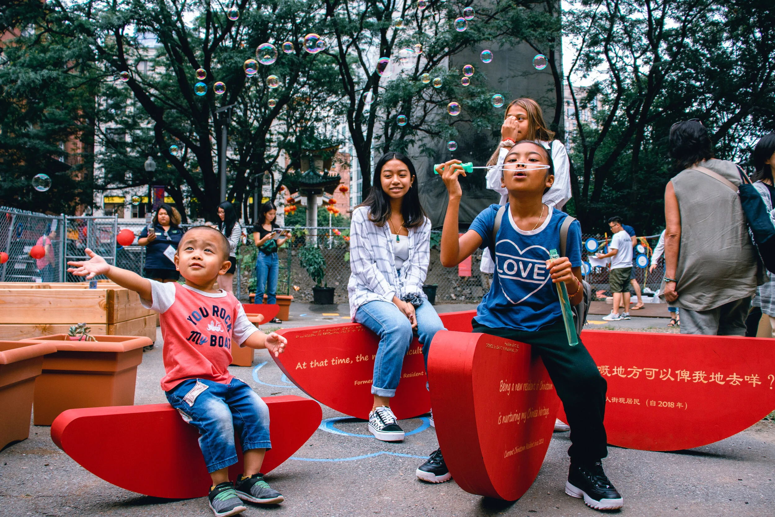 Children playing at the Chinatown Backyard grand opening, featuring public art by Ponnapa Prakkamakul in collaboration with Chinatown residents. Photo credit: Black Dog Pictures.