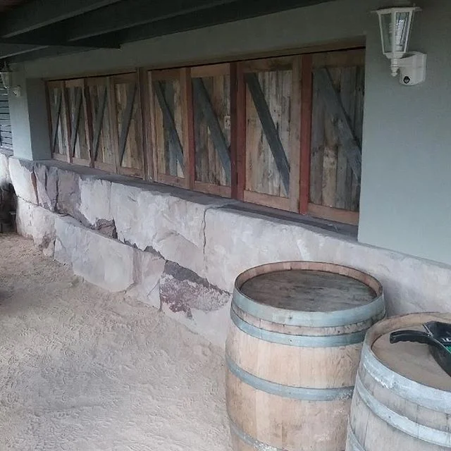 Custom made bifold doors made from old hardwood pallets for this bar and wine cellar in the Hunter Valley