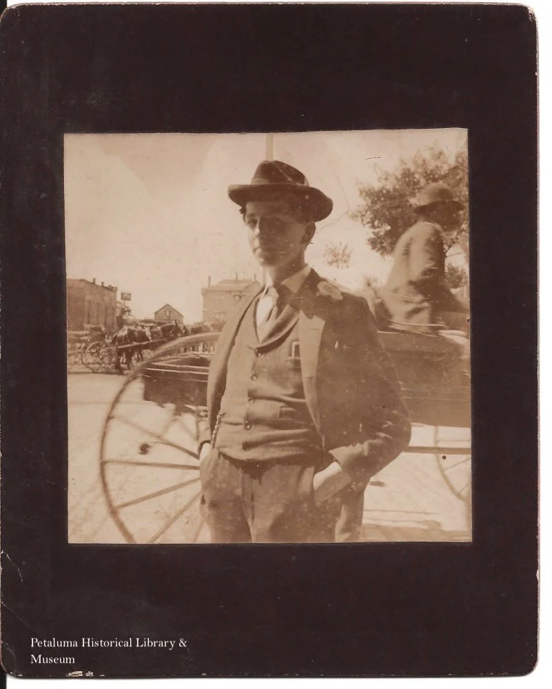A sepia toned photograph of Roy Crawford dressed in a suit with a vest and hat.
