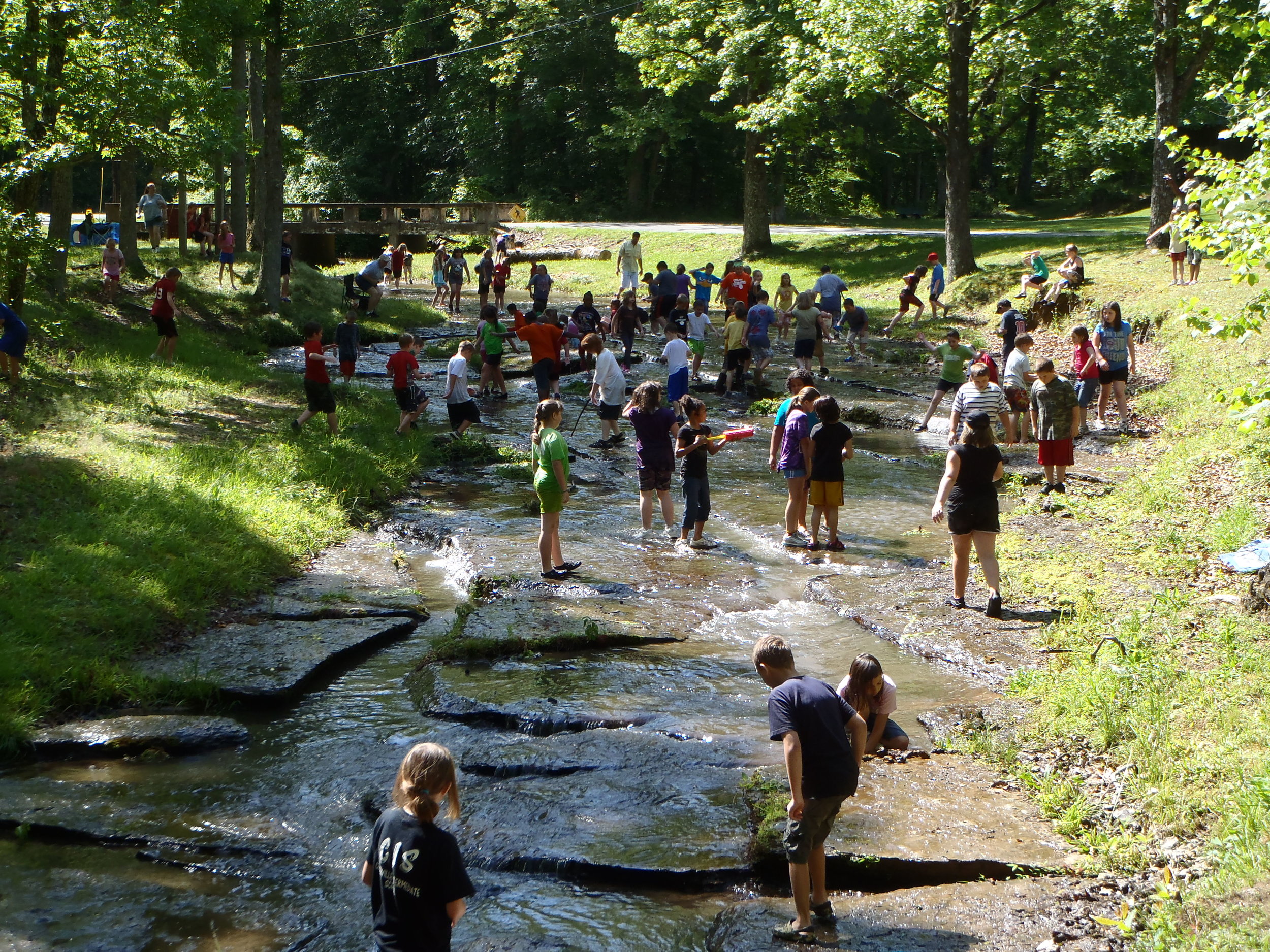  Lots of Summer Campers in a shallow part of a creek staying cool - NaCoMe Camp &amp; Conference Center 