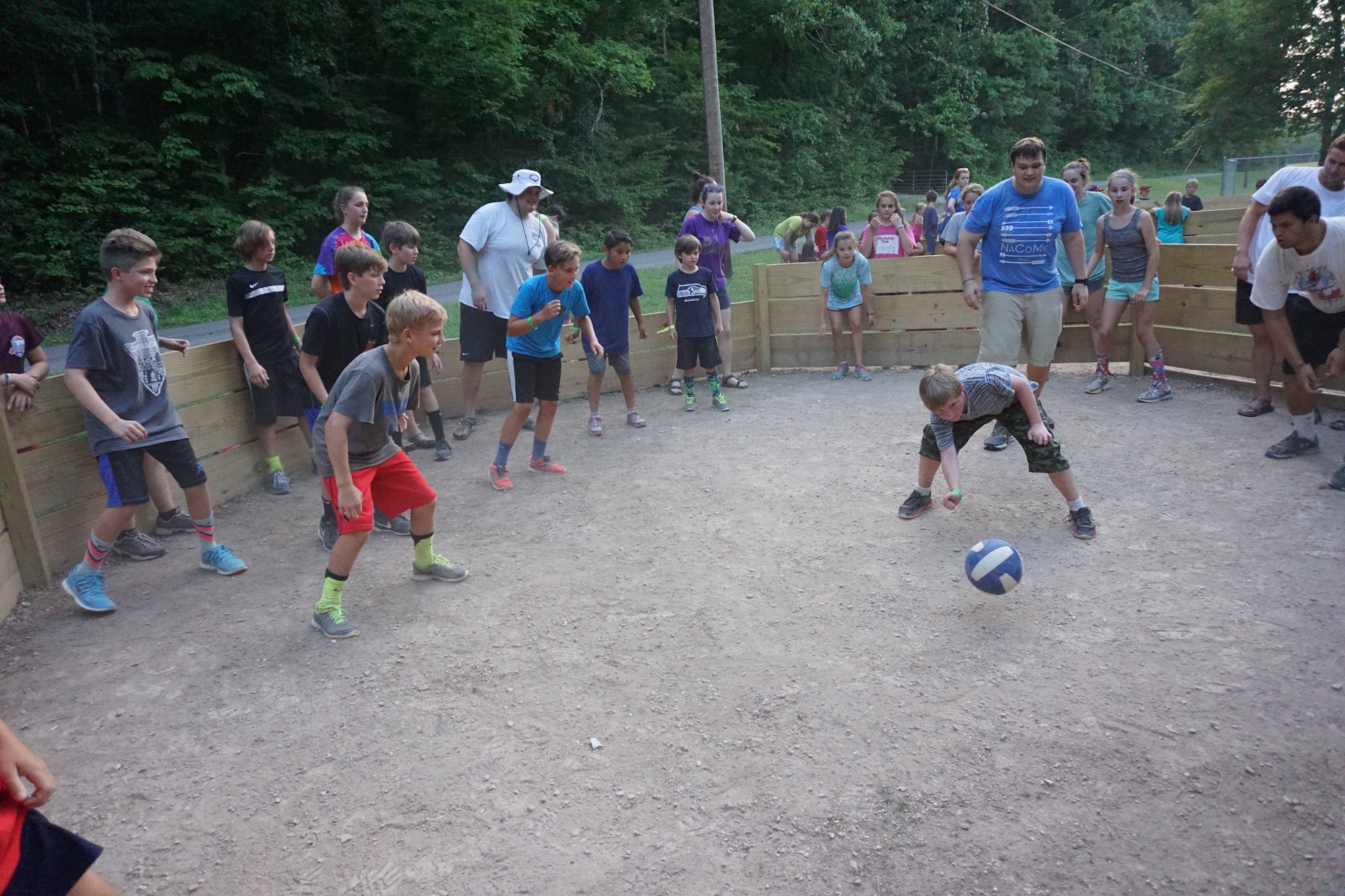  A circle of Summer Campers playing a game with a ball - NaCoMe Camp &amp; Conference Center 