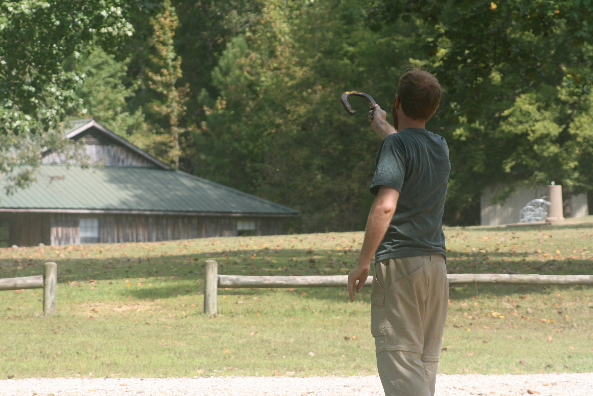  An adult Summer Camper playing horse shoes - NaCoMe Camp &amp; Conference Center 