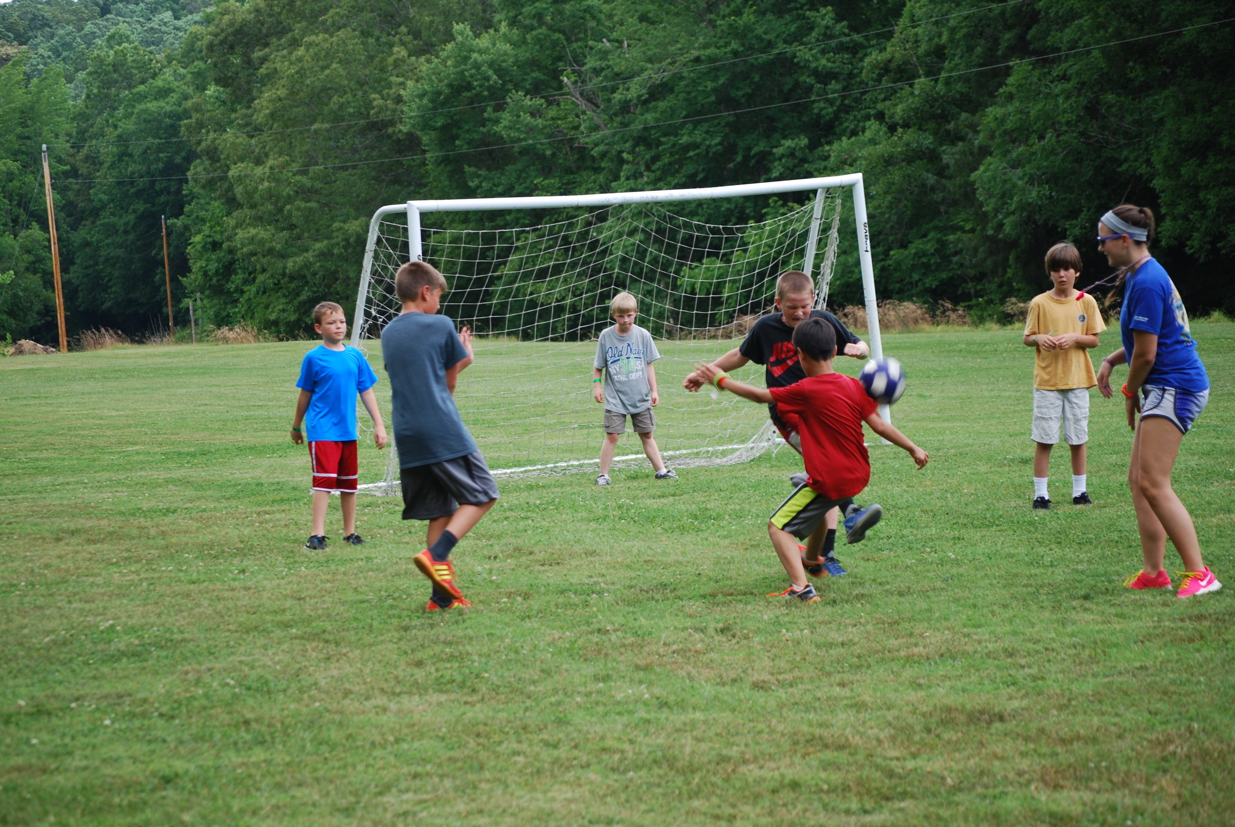  Young male Summer Campers playing soccer - NaCoMe Camp &amp; Conference Center 