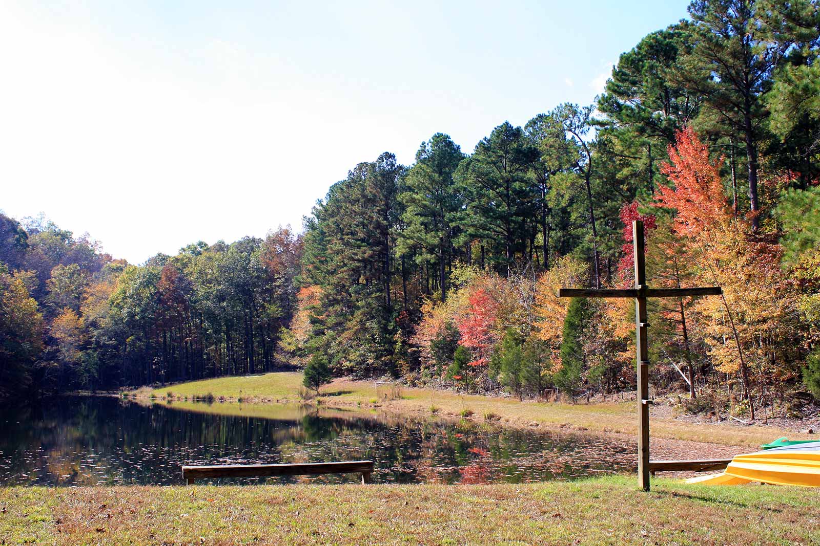 Copy of A beautiful new of the trees turning colors by a lake with calm water - NaCoMe Camp & Conference Center