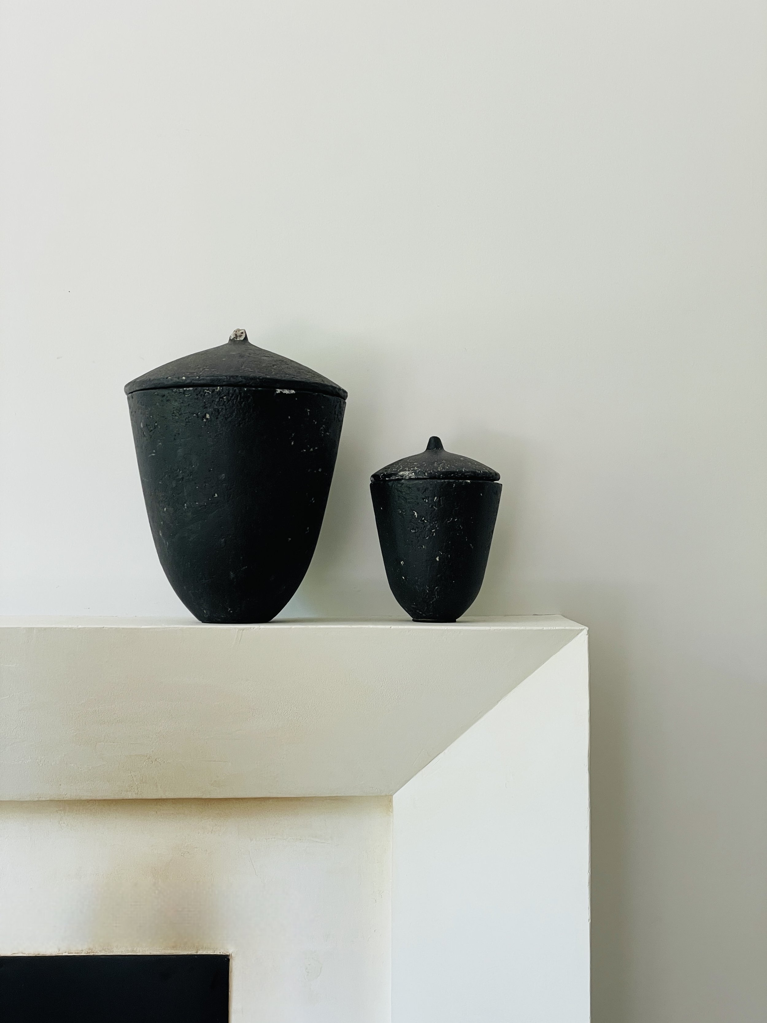 MATERI(A)NTIQUES SET OF 2 ACORN SHAPED BLACK COMPOSITE VESSELS.jpg