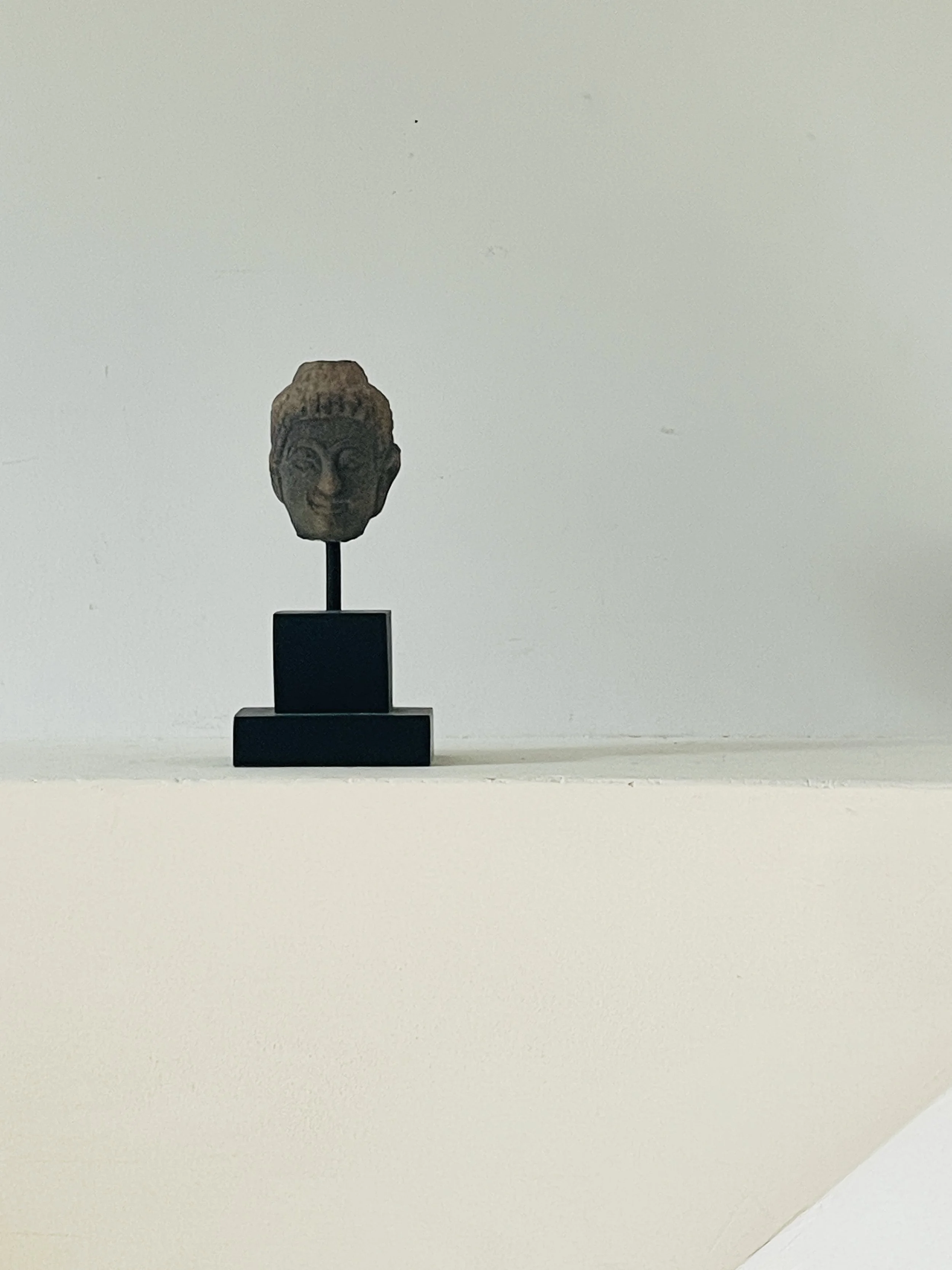 MATERI(A)NTIQUES SMALL CERAMIC BUDDHA HEAD ON BLACK STAND(2).jpg