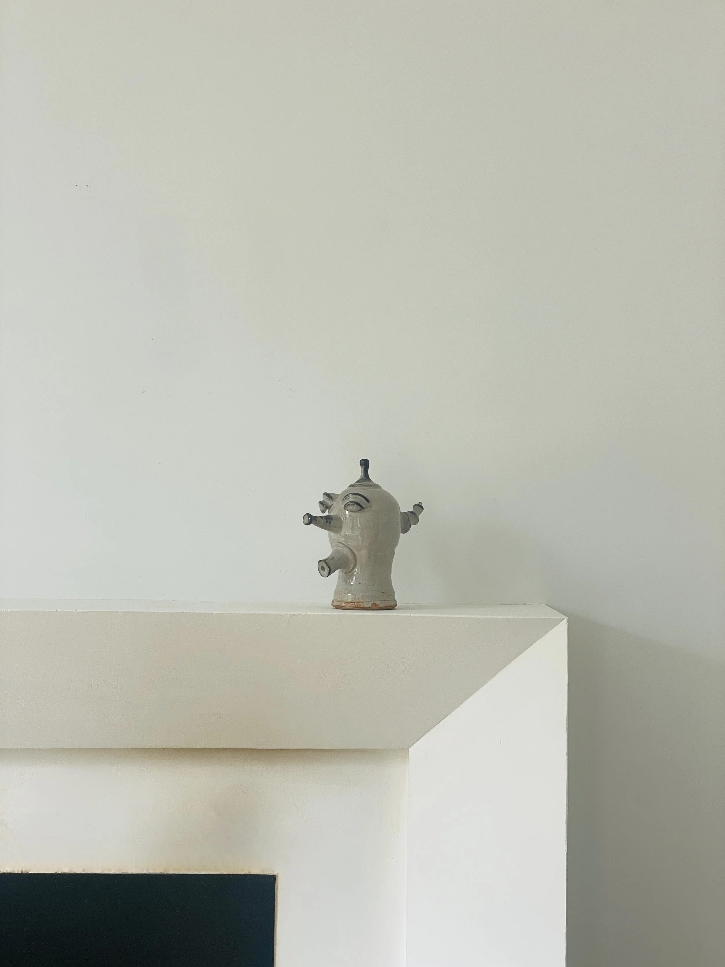 MATERI(A)NTIQUES MEDIUM IVORY AND GREY GLAZE CERAMIC FACE SCULPTURE