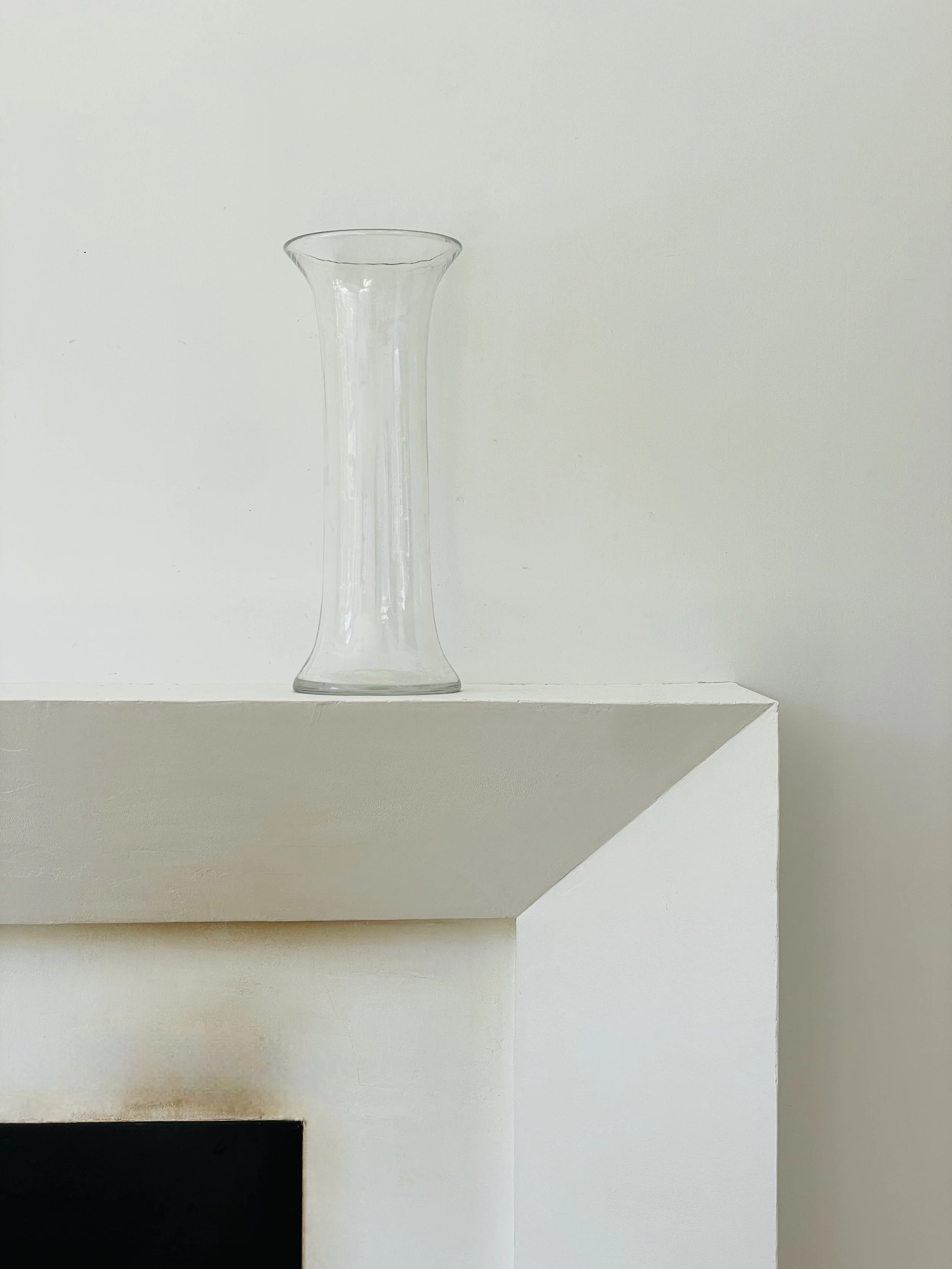 MATERI(A)NTIQUES TALL CLEAR BLOWN GLASS VASE WITH FOOT AND LIP.jpg