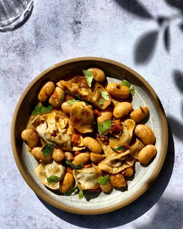 Frozen veggie dumplings jazzed up with tomato-y white beans and chopped parsley, one of @mackannecheese&rsquo;s favorite way to a balanced vegetarian meal. Pan fry the dumplings until they&rsquo;re crisp on one side, then add a can of big white beans