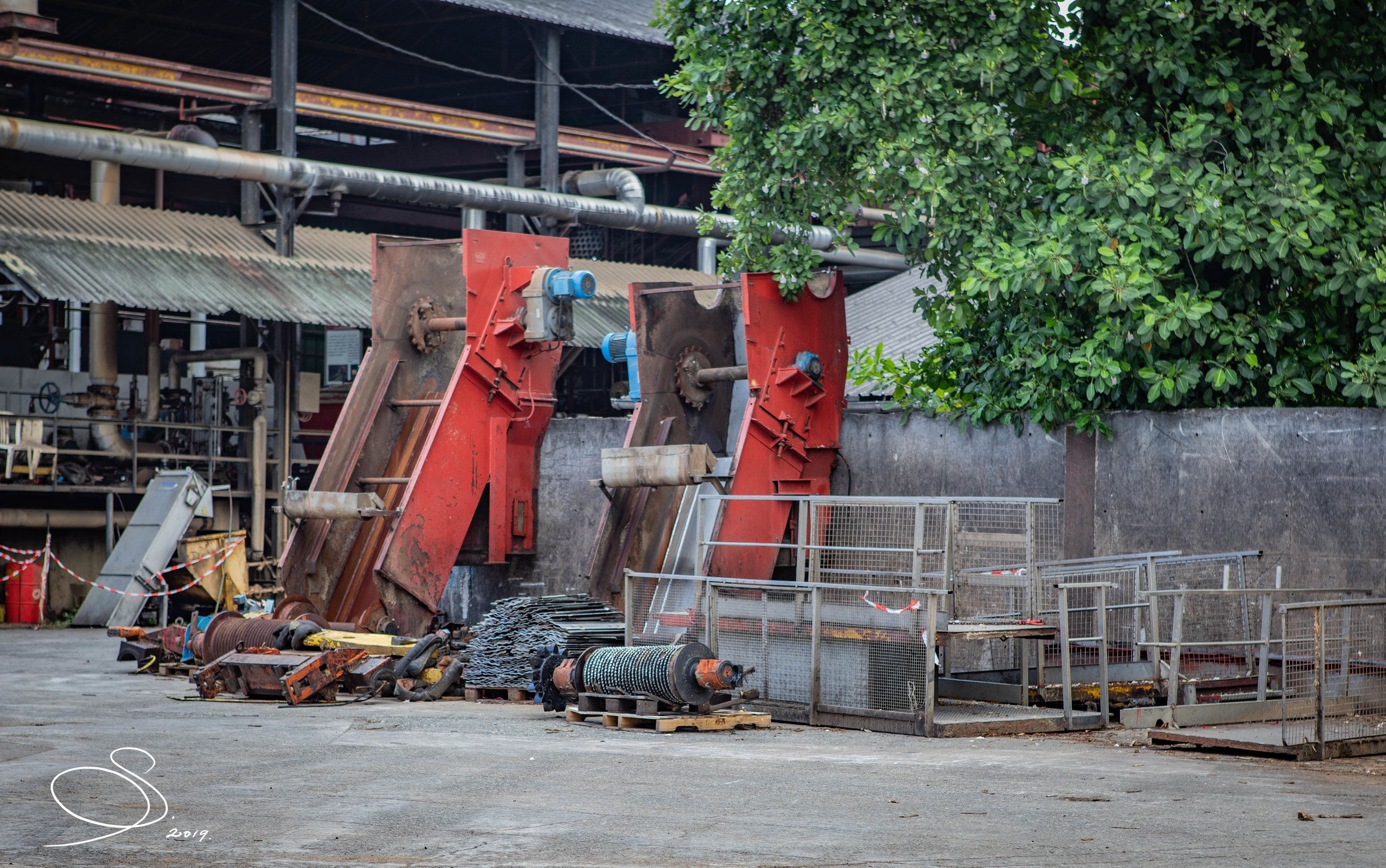Disassembled cane crusher towers, moulins and walkways