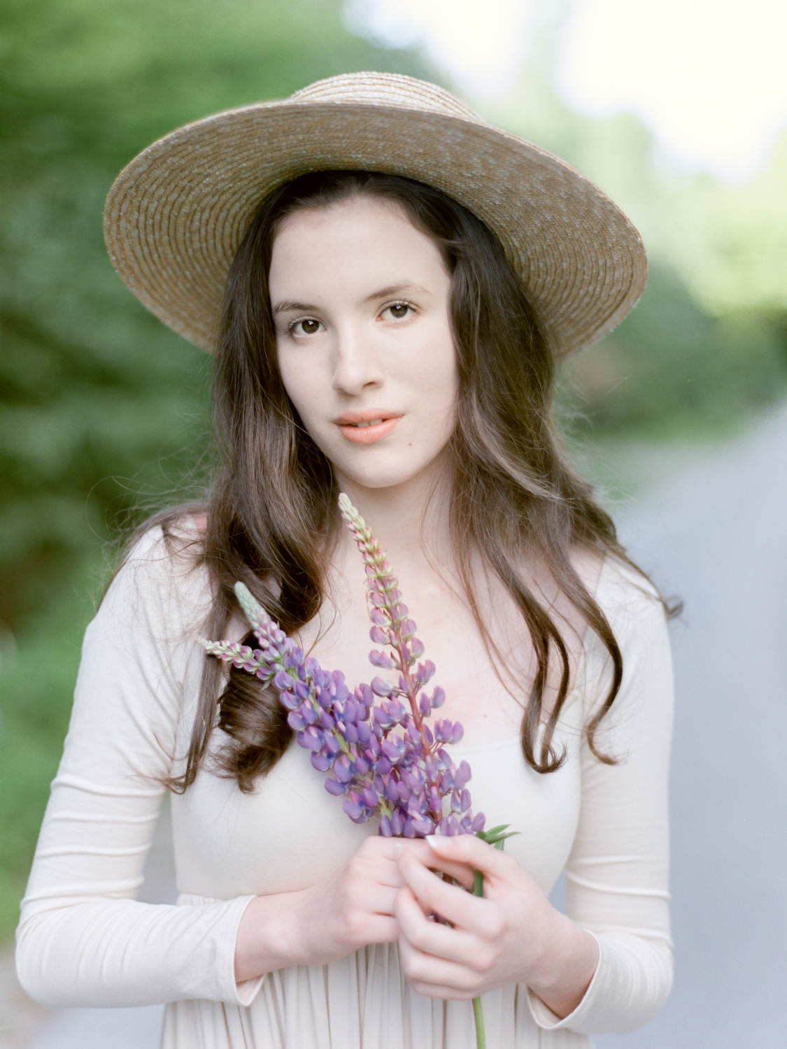 Jacqueline Anne Photography Captured on Film, Woman in cream dress and sunhat holding purple lupine florals