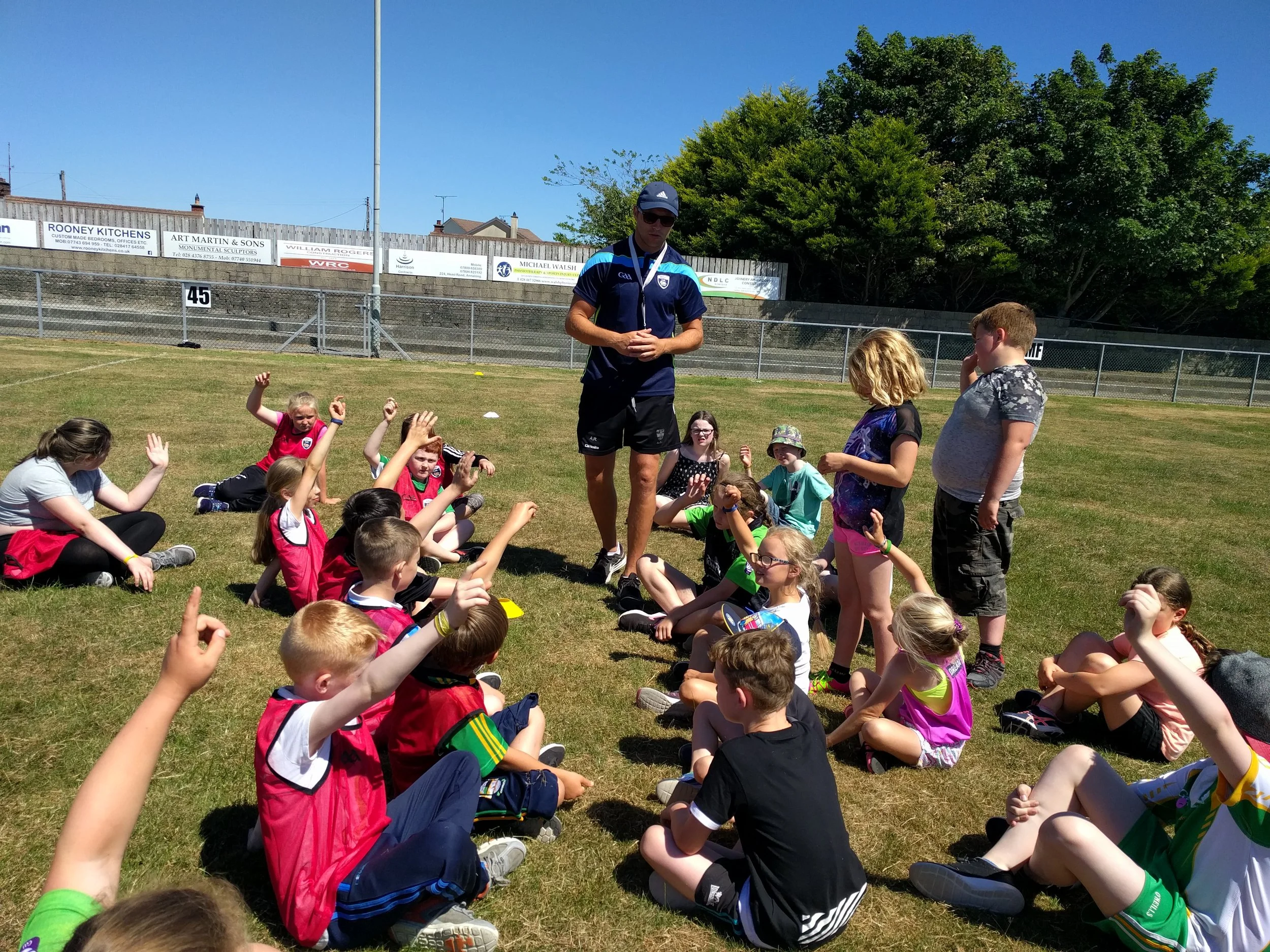Down GAA Coach Ambrose Rodgers coaching the children at Scoil Samhraidh.jpg