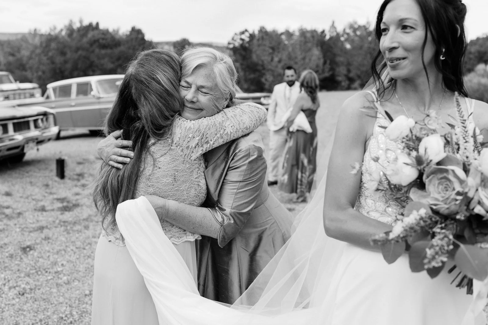 Black and white photo of bride hugging candid moment wedding photography in Escalante Utah at Ofland Escalante