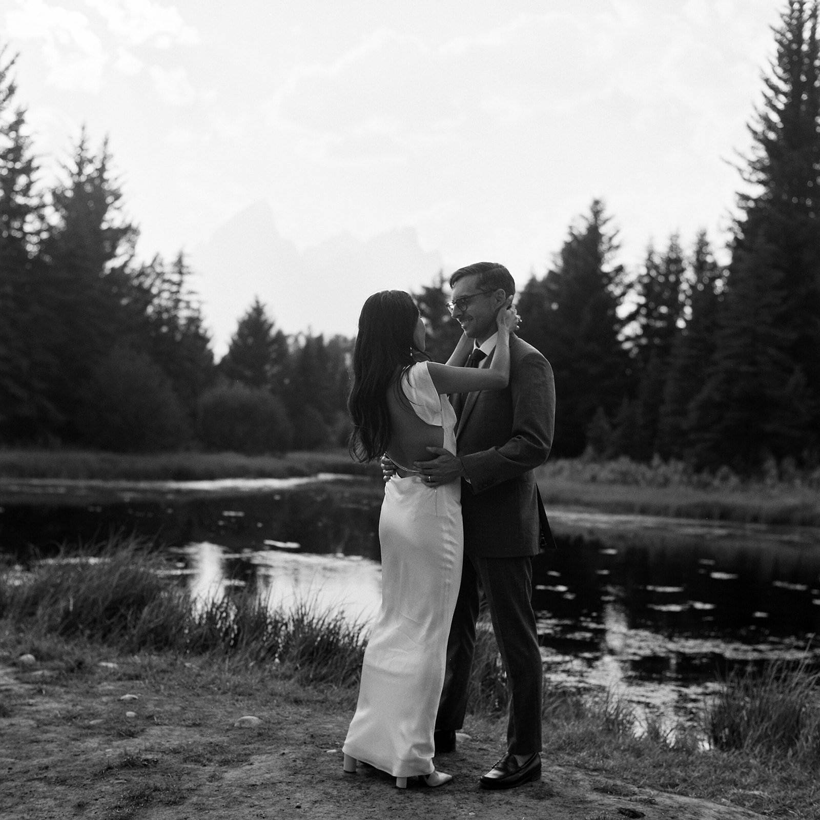 couple sharing their first dance at schwabacher landing in grand tetons national park