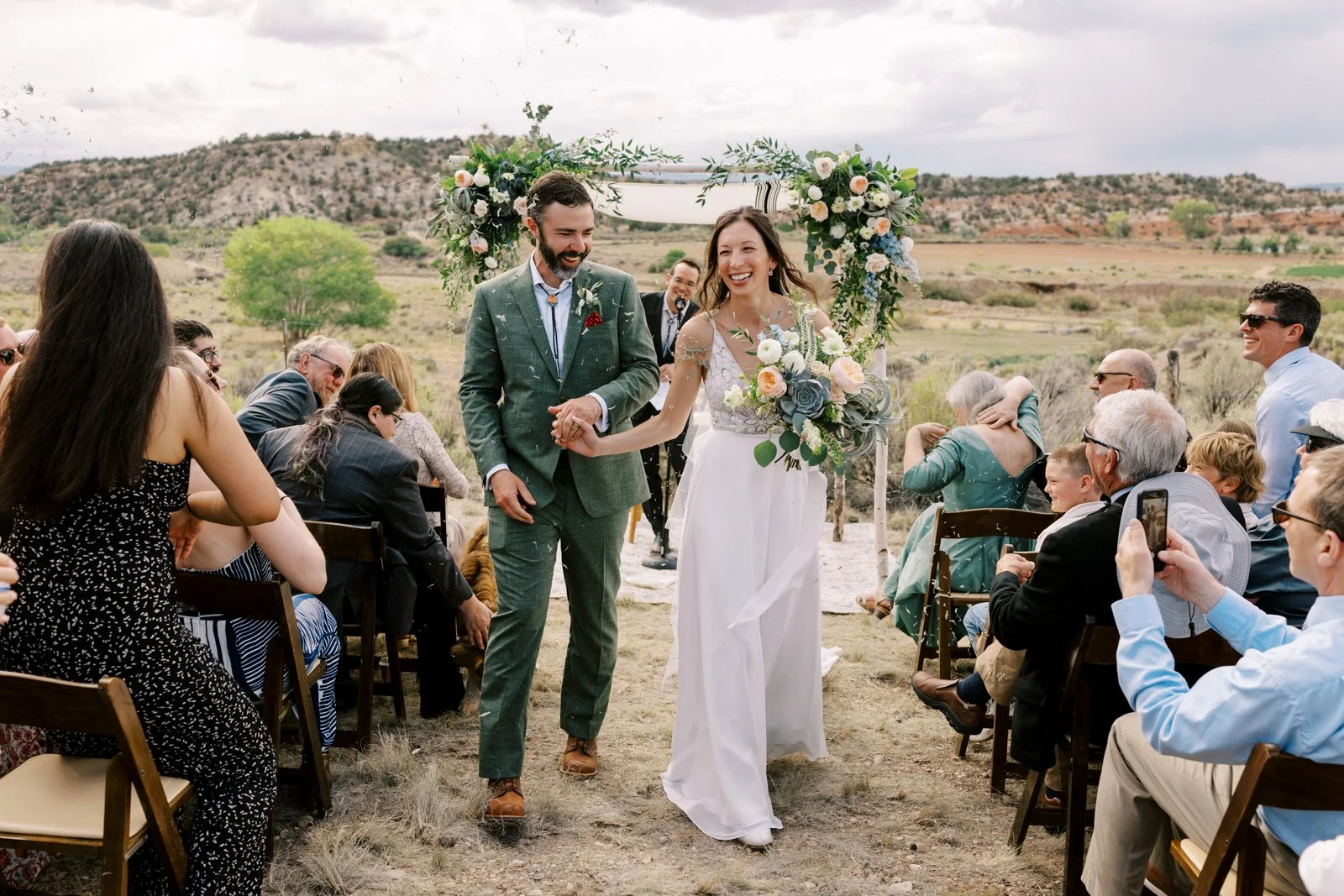 Bride and groom exit their wedding ceremony at Ofland Escalante in Utah
