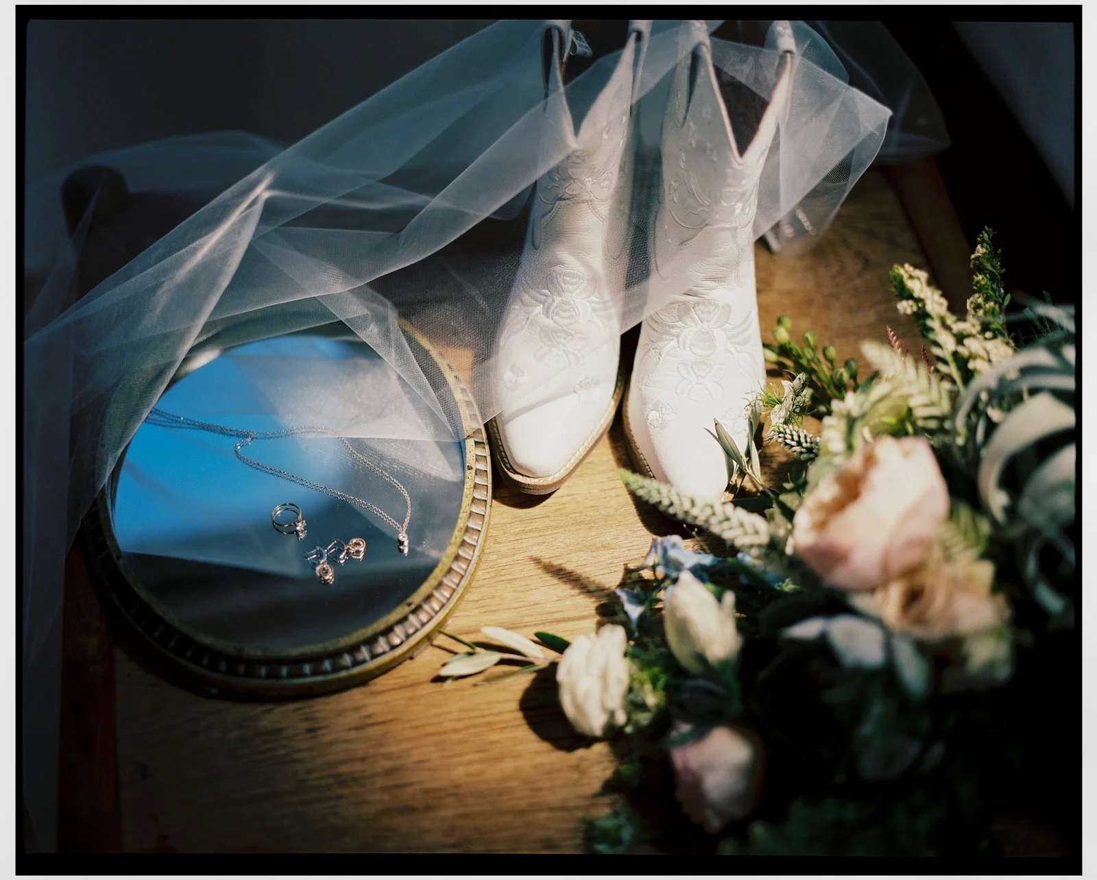 Film photographer Boulder Escalante wedding at Ofland Escalante. Wedding at grand staircase escalante capitol reef wedding. Wedding details of cowboy boots and flowers photographed on film