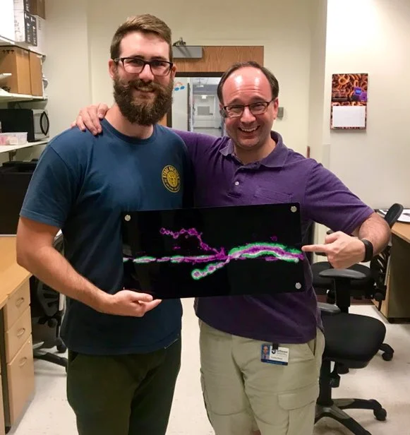 Lucas and Tim with Lucas’ goodbye gift from the lab - a metal print of his first major result!