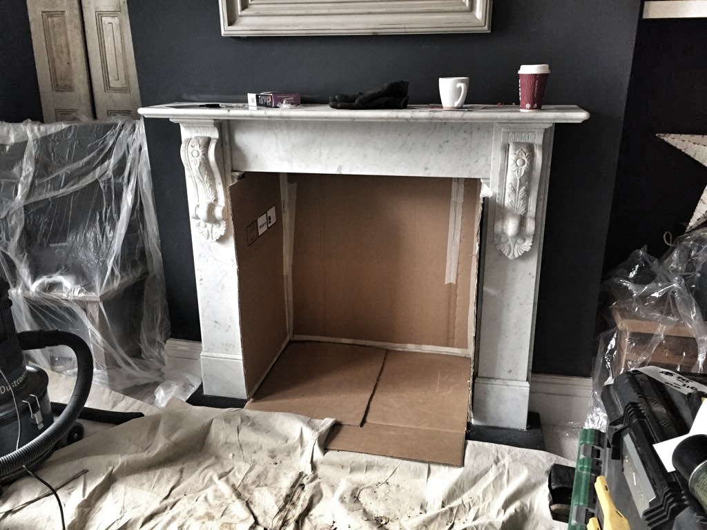 The tiles were covered up to keep them safe during the stove install