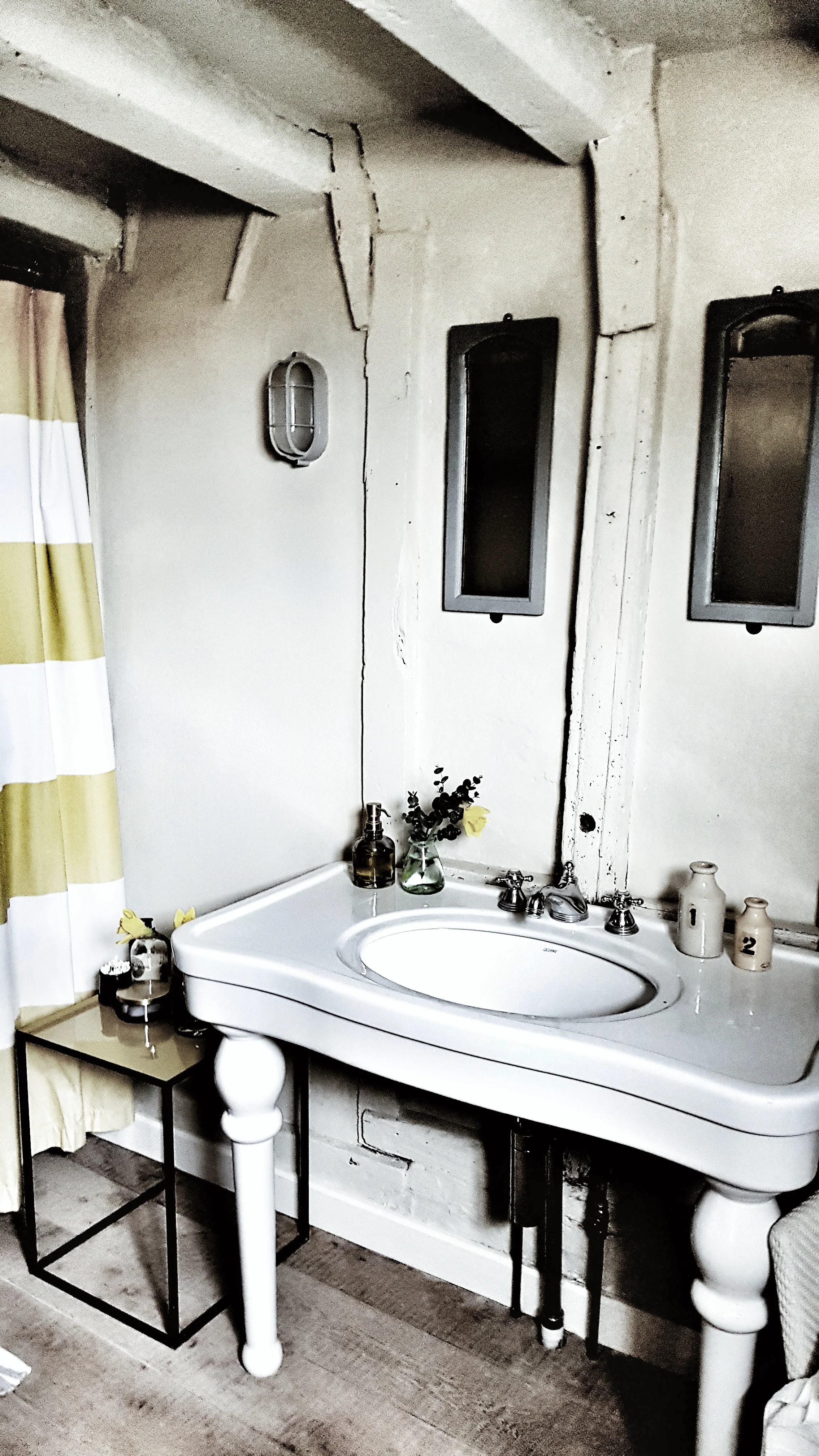 The vintage sink and vanity area in the gorgeous rustic bathroom