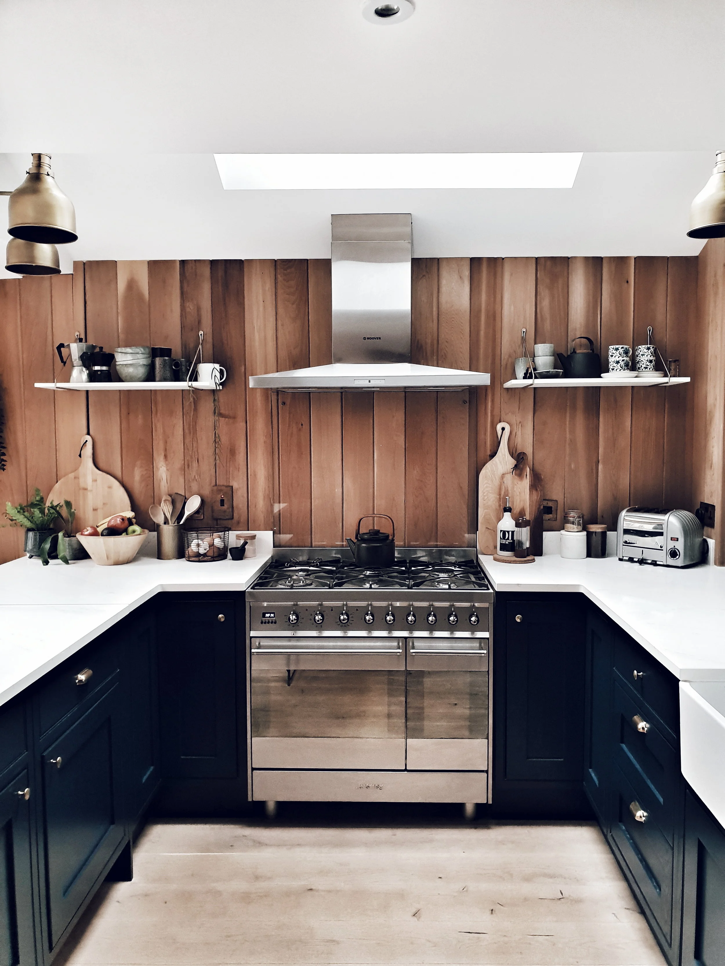 The kitchen that made me click follow on Maz’s Instagram account @the_ wooden _hill with its stunning navy cabinets, brass handles and timber clad walls
