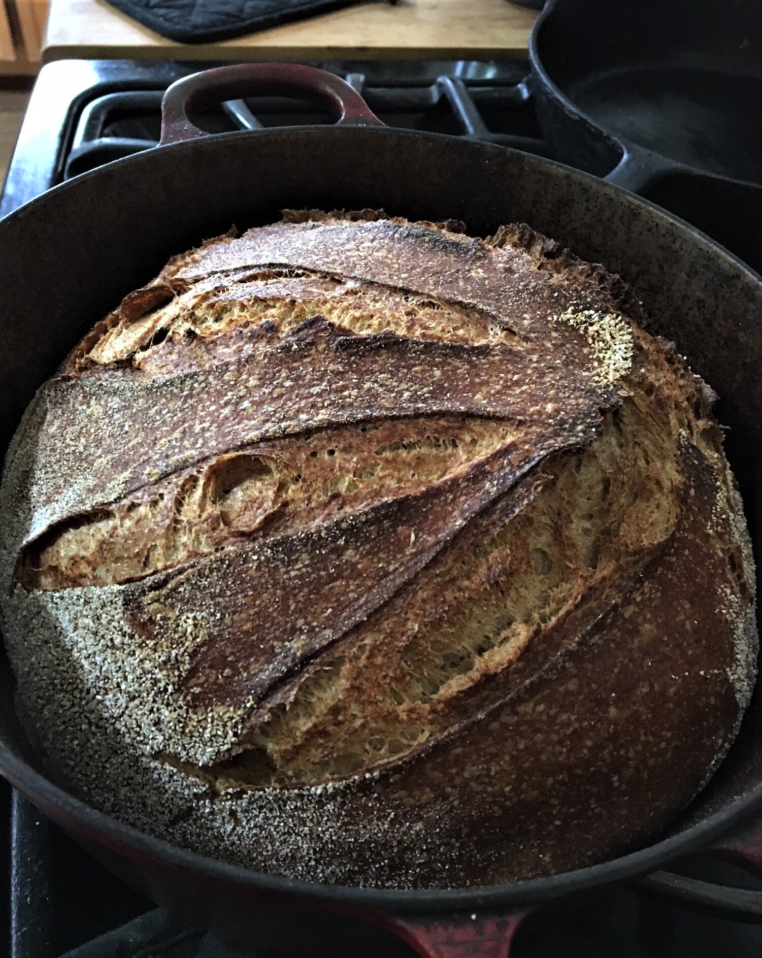 This was my 3rd attempt at a sourdough loaf, and despite only having a cast  iron skillet and a metal mixing bowl as a Dutch oven, I think it turned out  pretty