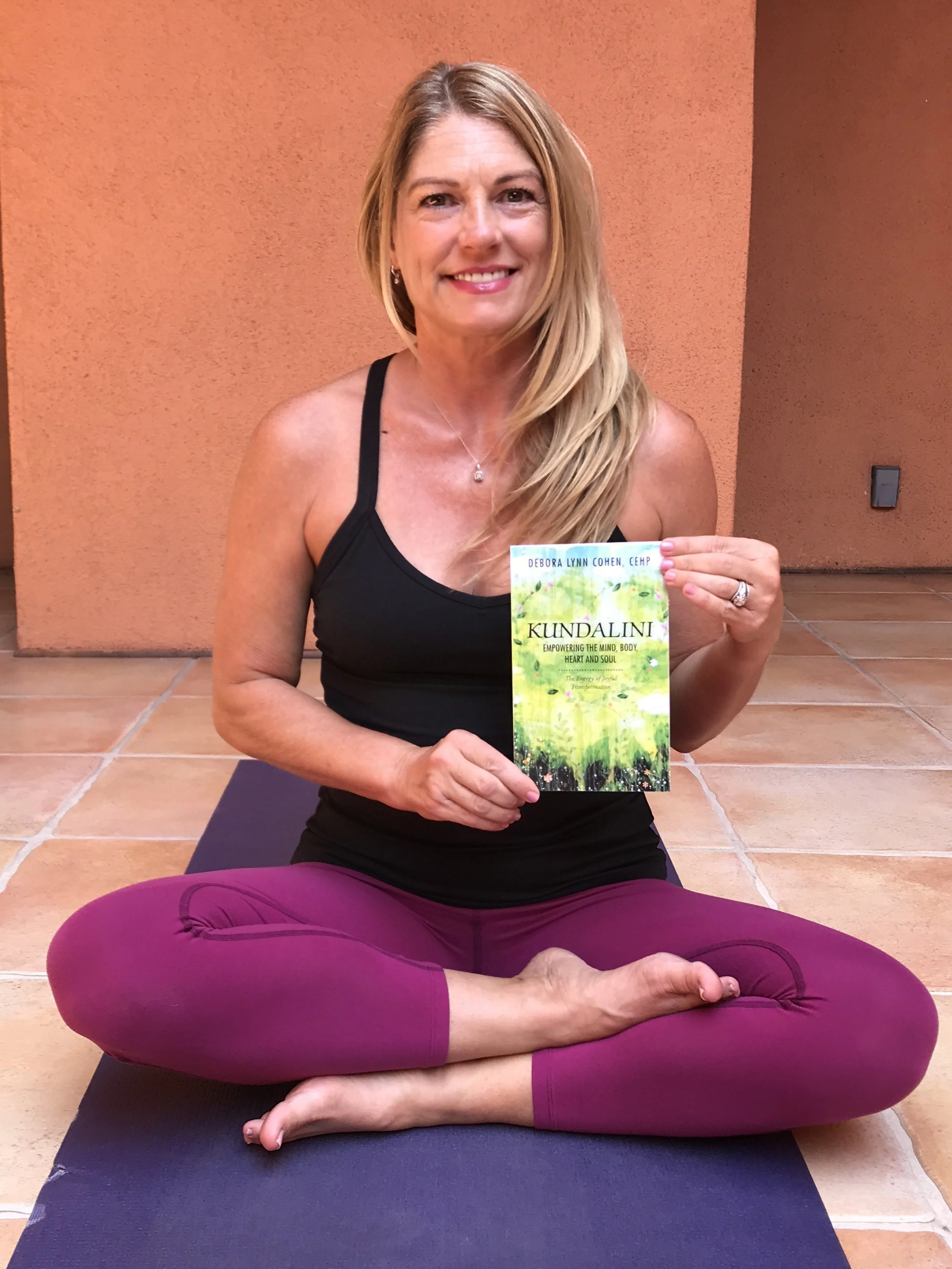 Debora cross legged seated w her BookIMG_1158.JPG
