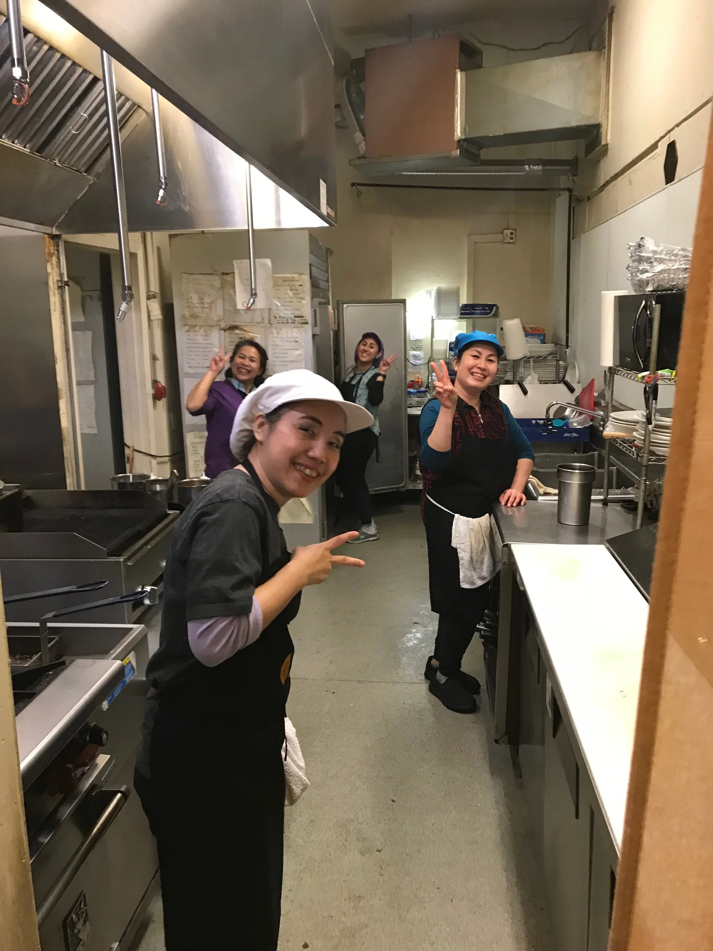 Joyful cooks flashing a peace sign.jpg*.jpg