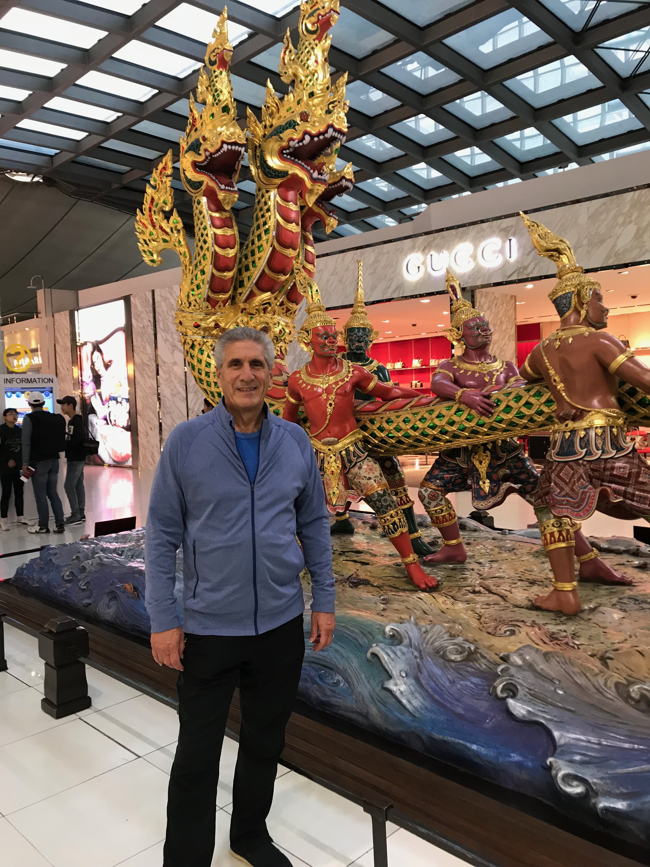 Dennis in front of statue Thai airport.jpg*.jpg