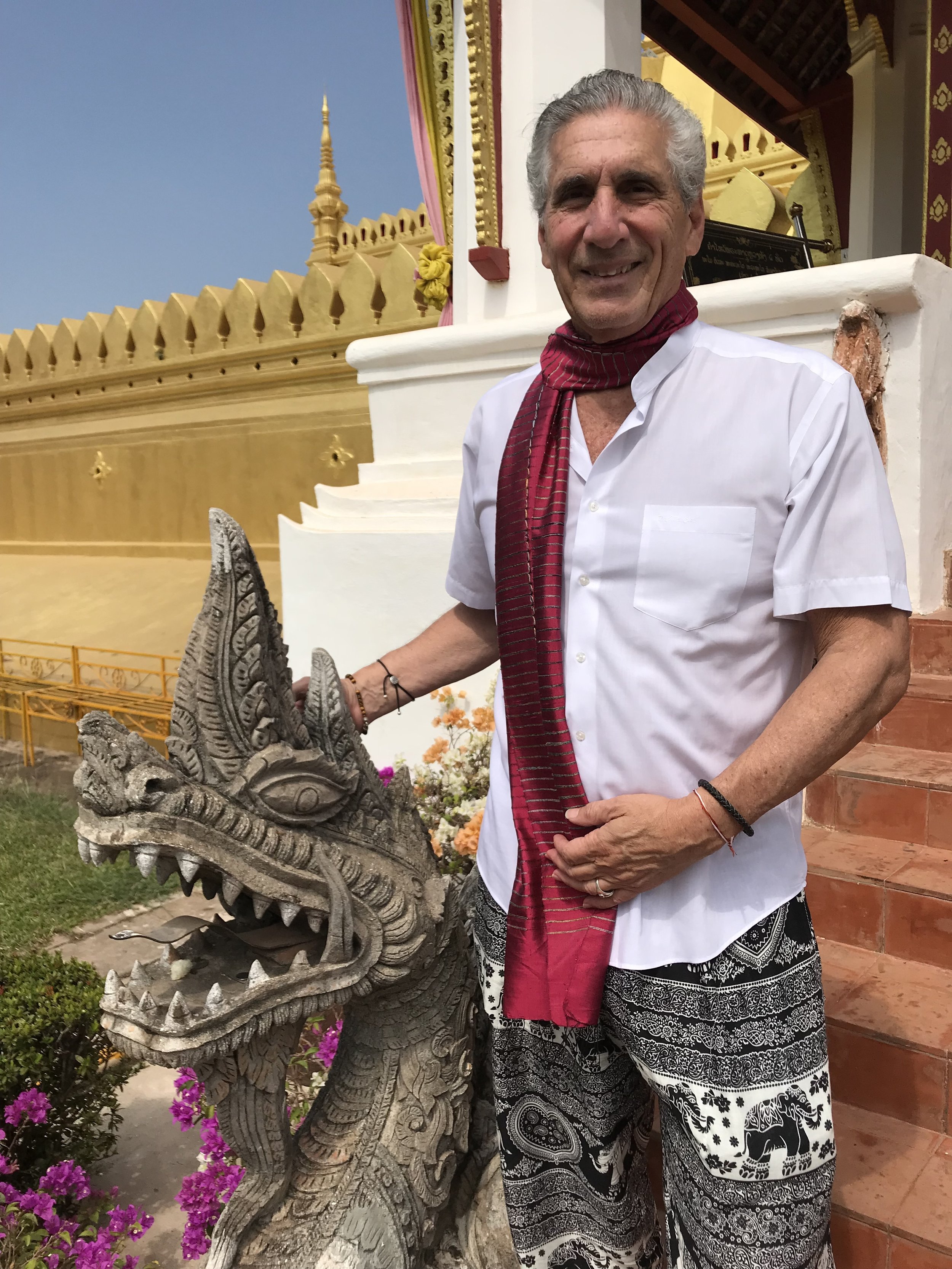 Dennis w Serpent guariian at  Wat That Luang .jpg*.jpg