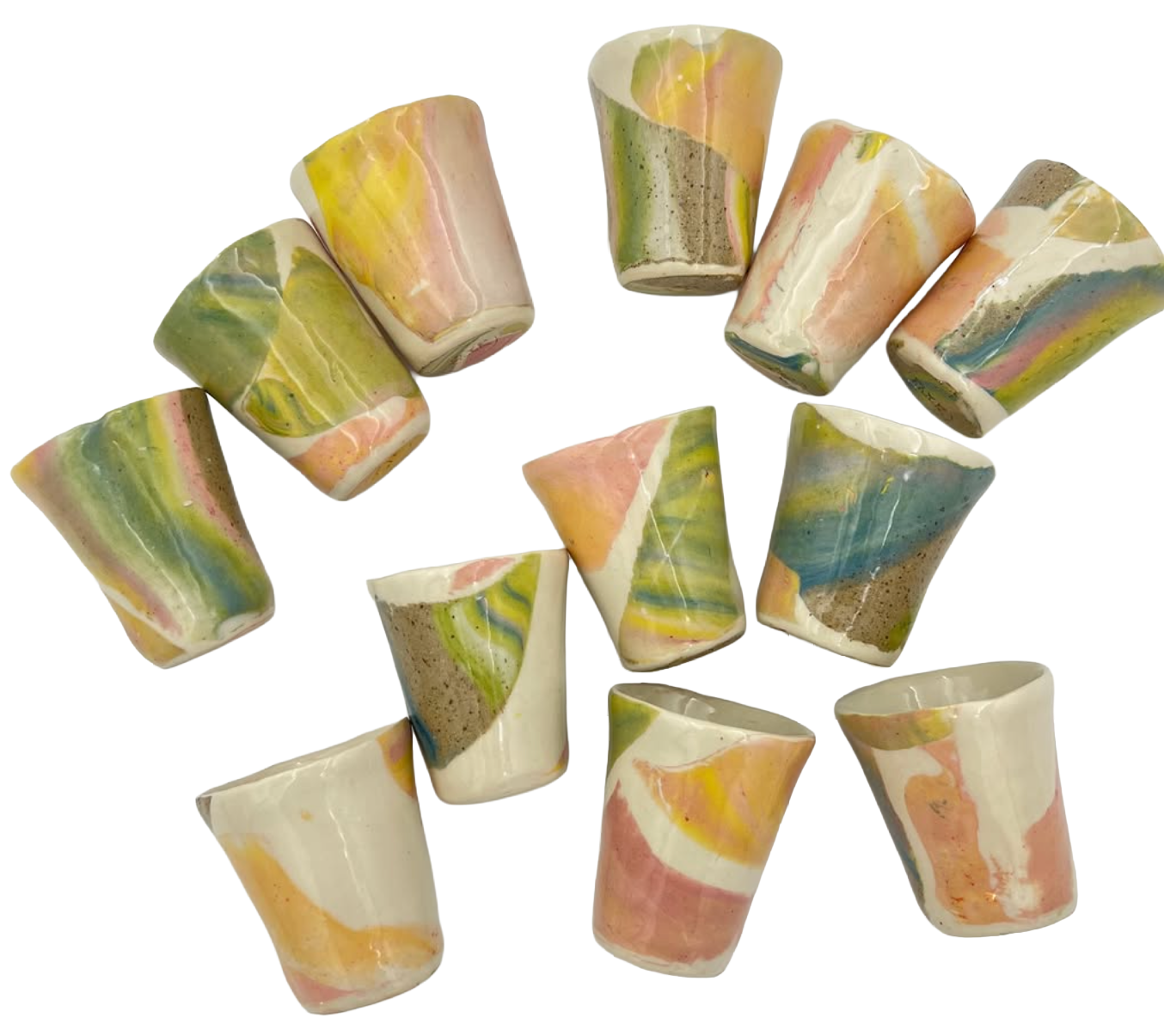 Colorful marble-patterned ceramic cups arranged in a circle. They have streaks of green, yellow, pink, blue, white, and beige.