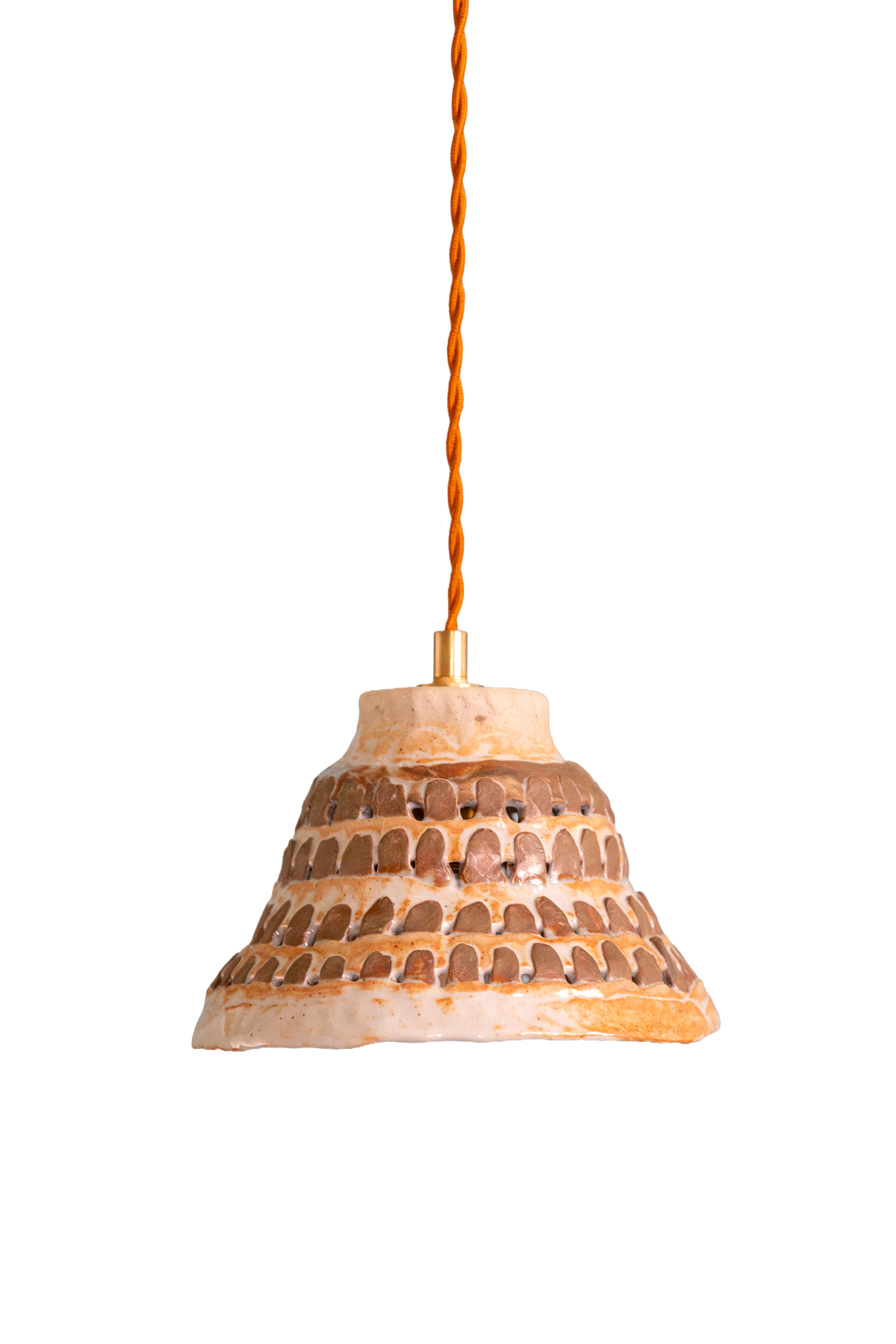 Close-up of a tiered ceramic lamp with a textured pattern, a gold-colored socket, and an orange twisted cord hanging from the ceiling.