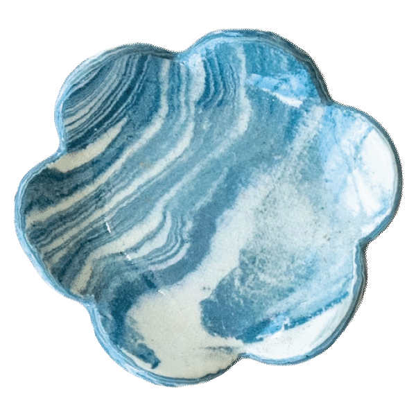 A polished blue and white marbled stone in a flower-like shape.