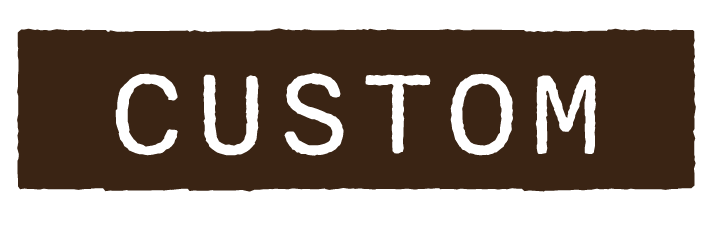 Brown sign with the word 'CUSTOM' in black uppercase letters.