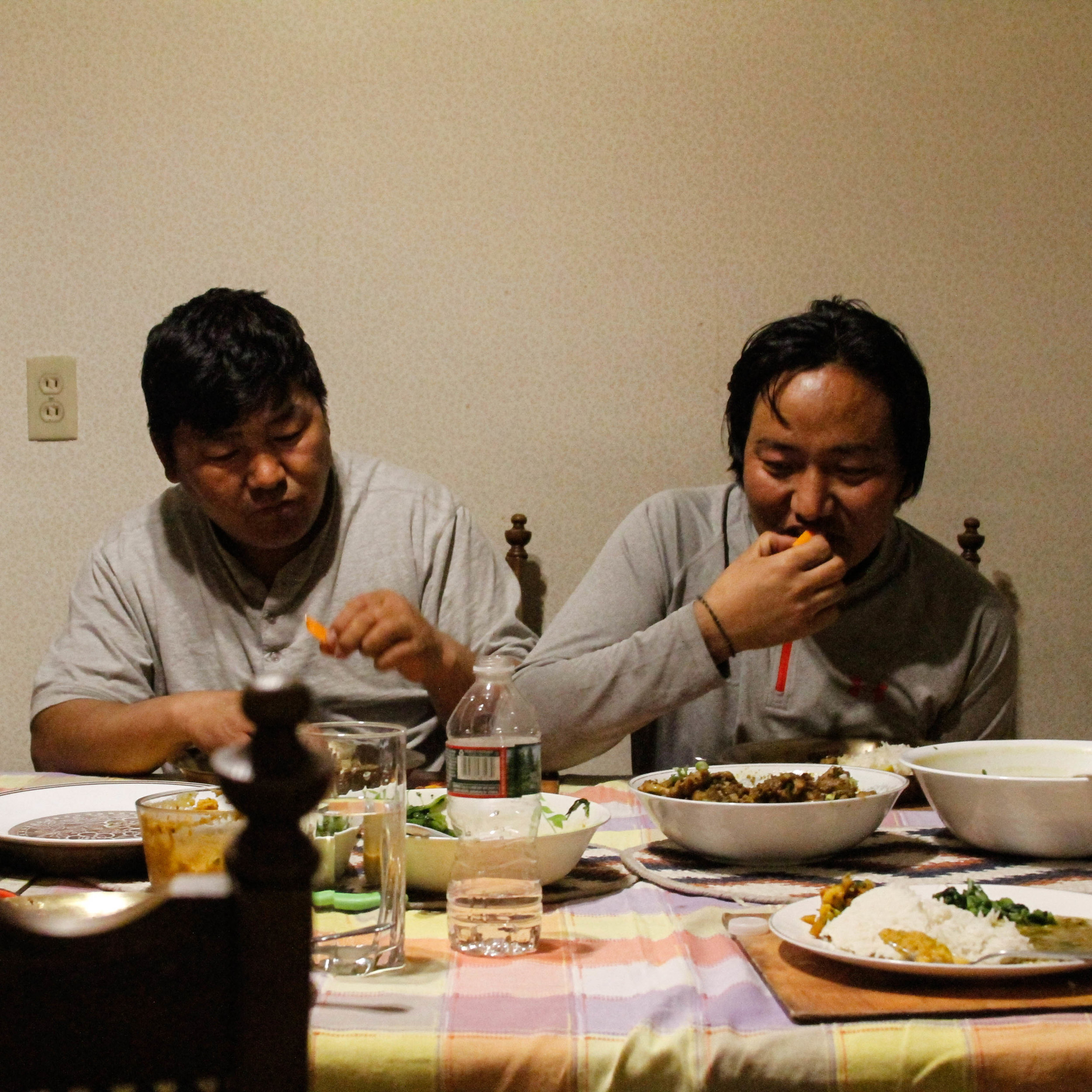  Jigme and another Mustangi worker share a Nepali meal together.&nbsp; 