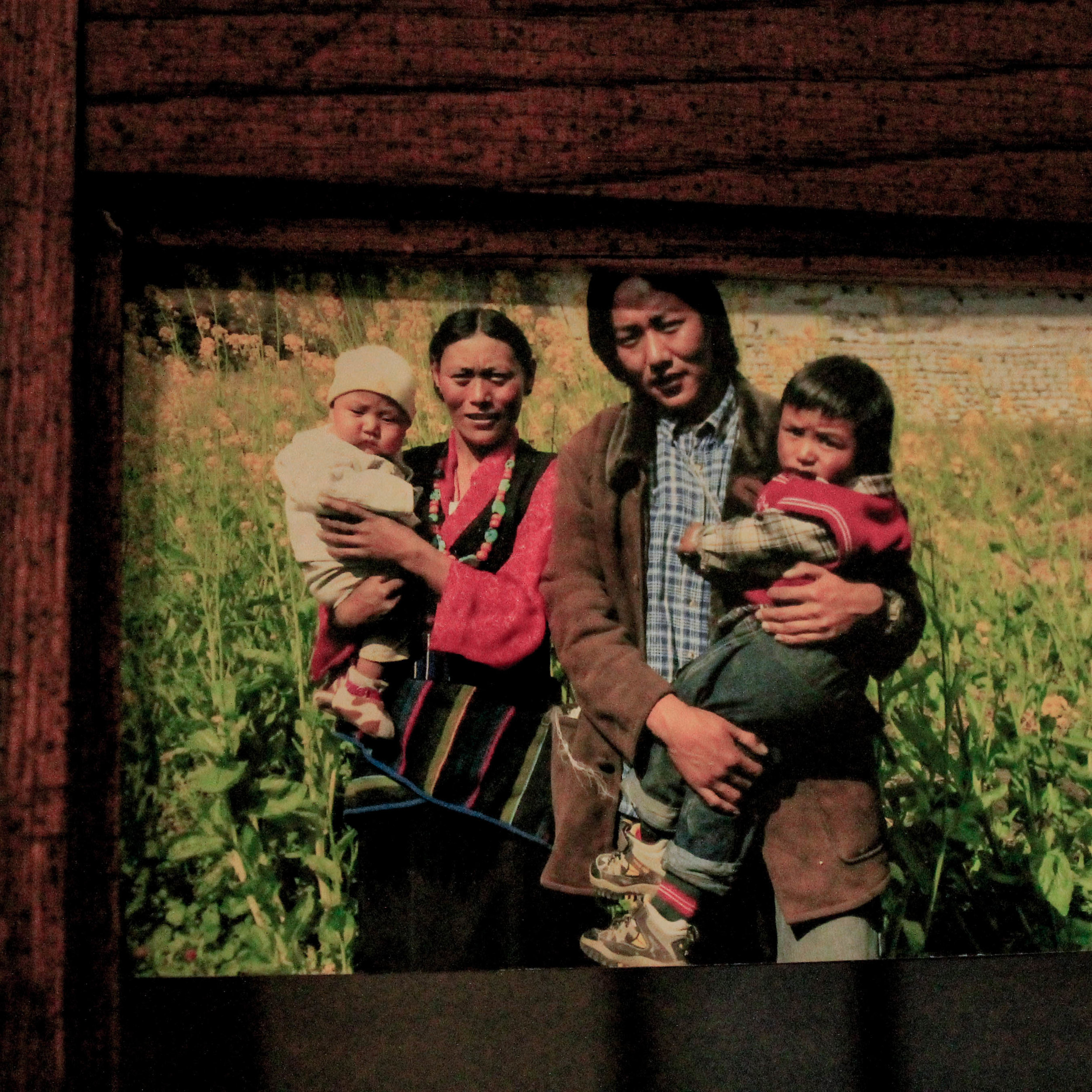  A photo of Jigme, his wife, and two of their three children hangs in the dining room.&nbsp; 