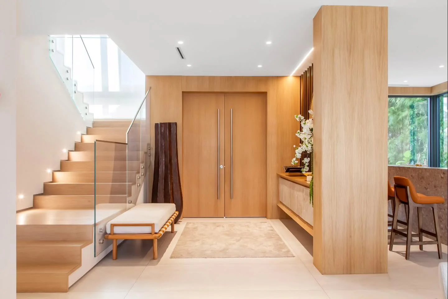 Shores Residence | Before &amp; After

From traditional to contemporary. Warm wood, glass, and natural stone come together to transform this entry foyer into a striking yet inviting entrance.

#InteriorDesign #LuxuryInteriors #EntrywayDesign #HomeTra