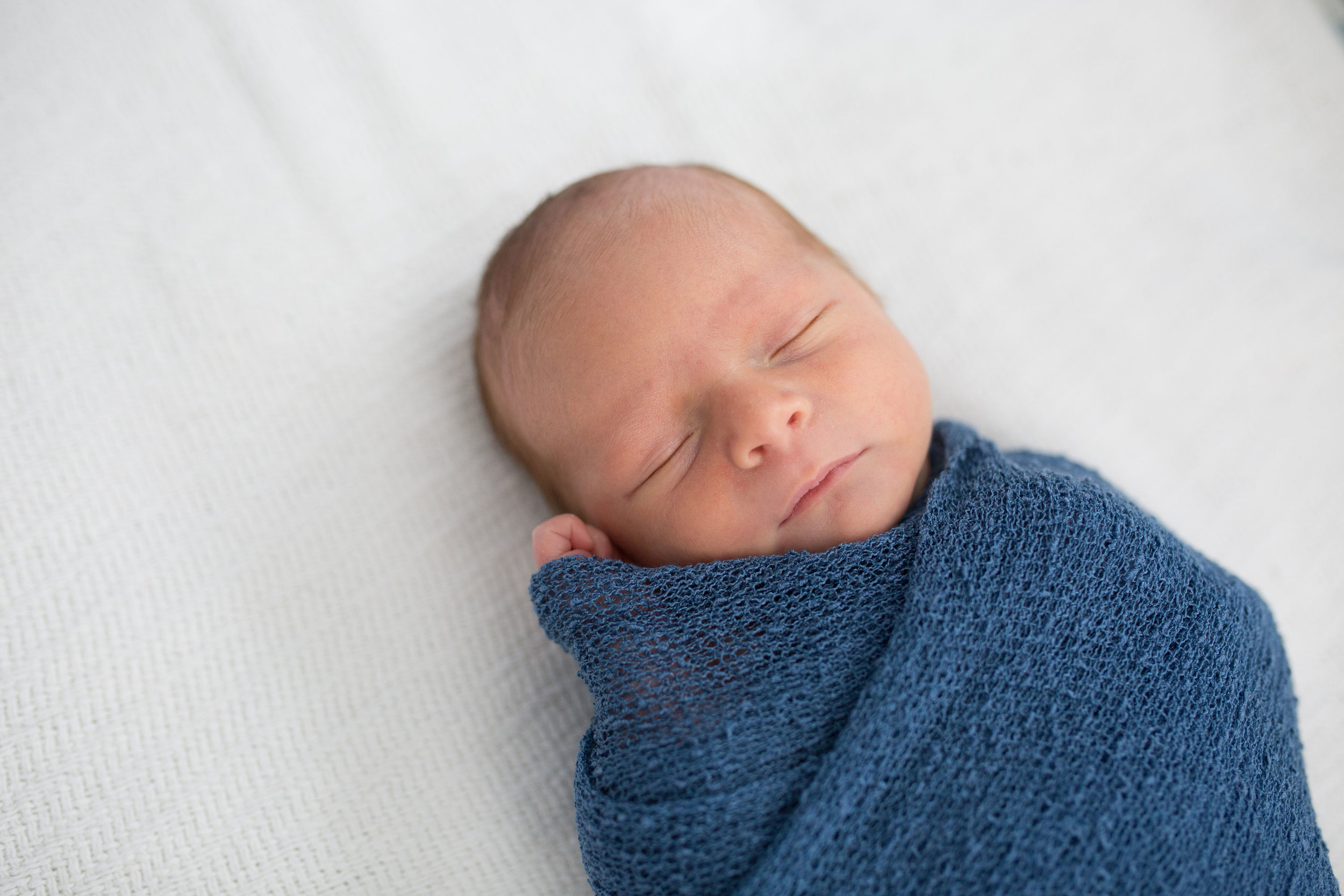 newborn at home session swaddled