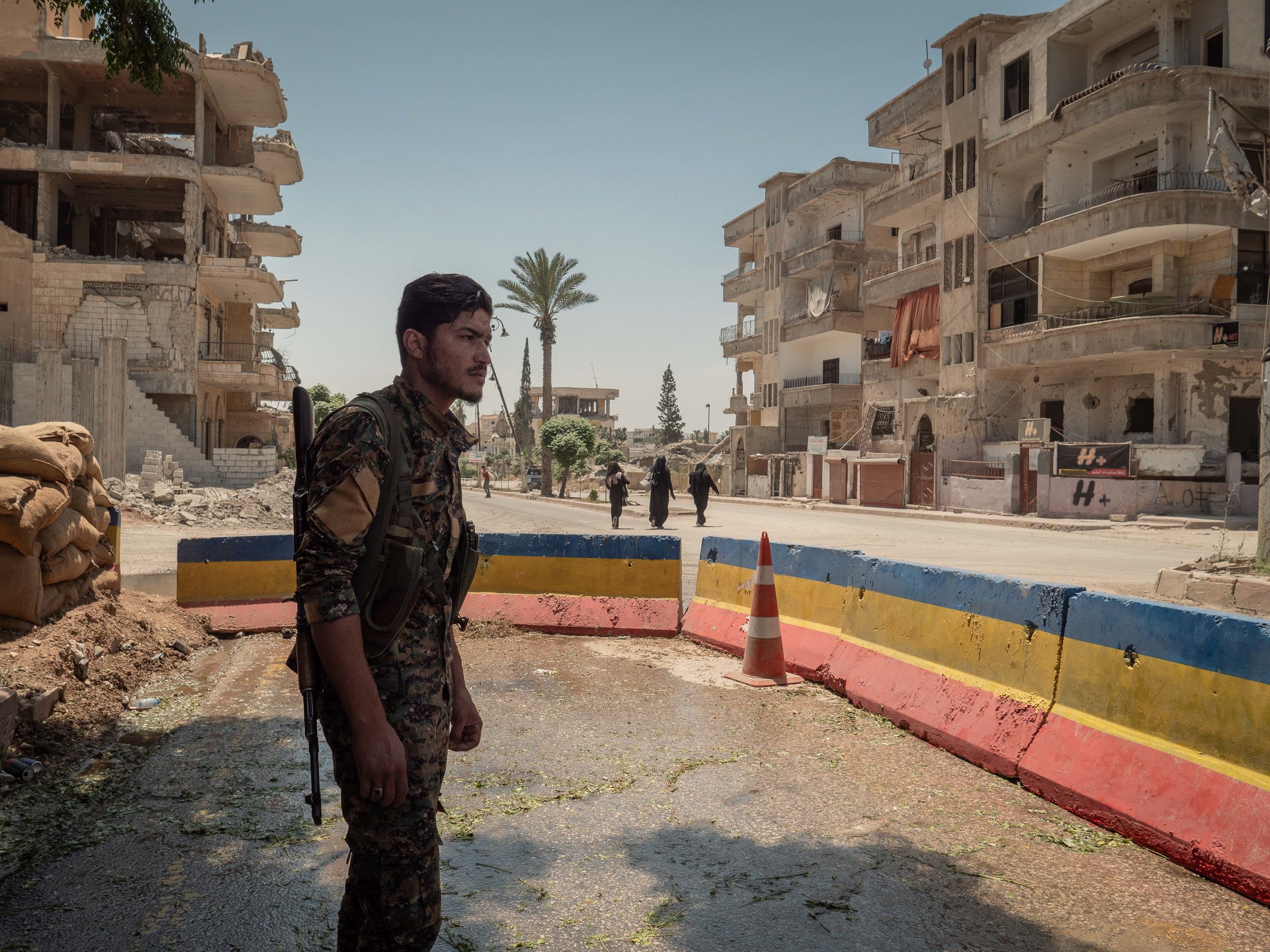29/05/19, Raqqa, Syria - A member of the security forces patrols the headquarter in Raqqa near the site of a suicide attack.