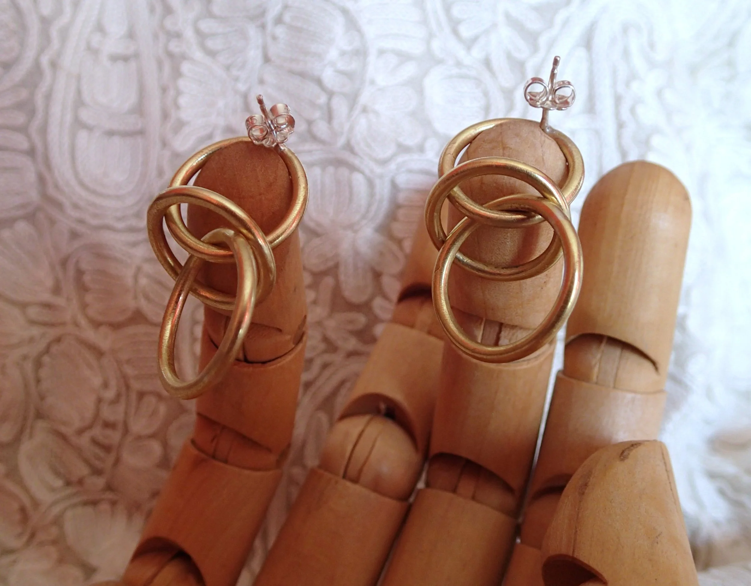 Orbit earrings brass sm hand.JPG