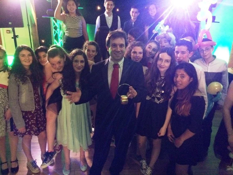 Matthew Garrett performing close-up magic at a family celebration and Mitzvah event