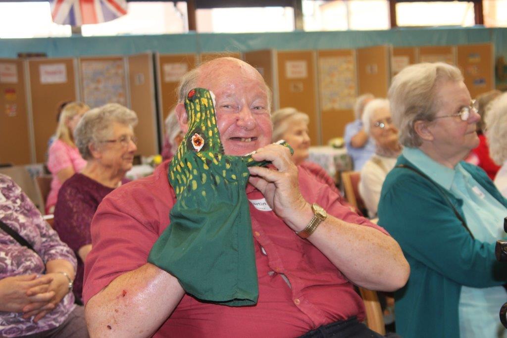 Matthew Garrett performing a magic show for residents at a care home