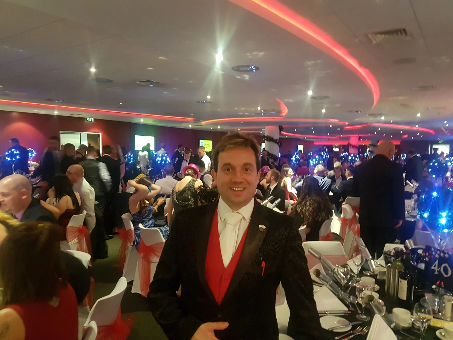 Matthew Garrett performing table magic for guests at an evening dinner event
