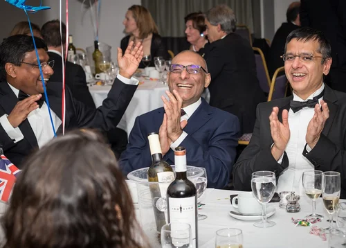 Guests enjoying close-up magic with Matthew Garrett at a professional dinner