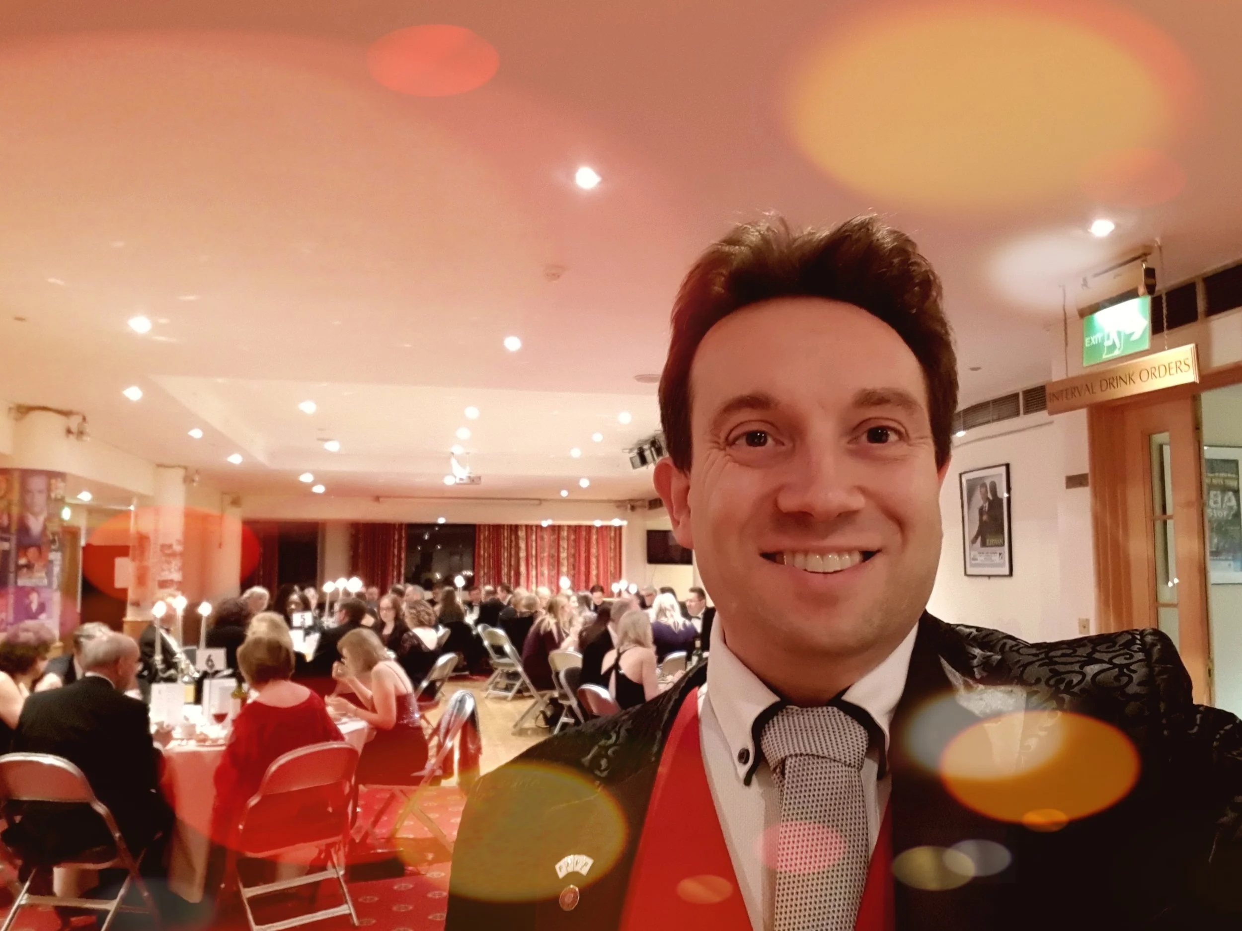 Close-up magician performing at a Law Society dinner at Bedford Corn Exchange