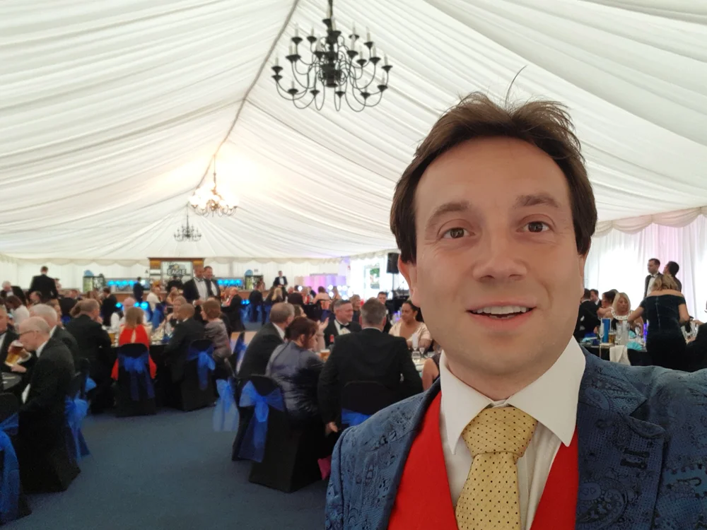 Matthew Garrett entertaining guests with close-up magic at a Bedford Rugby Club dinner